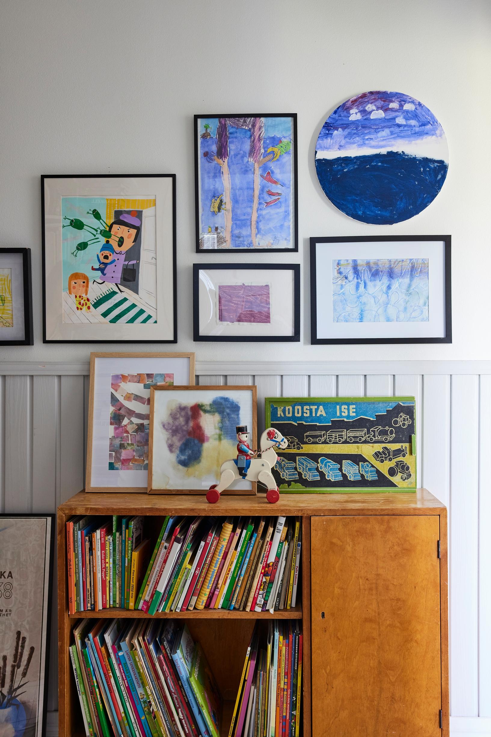 A gallery wall above a book cabinet