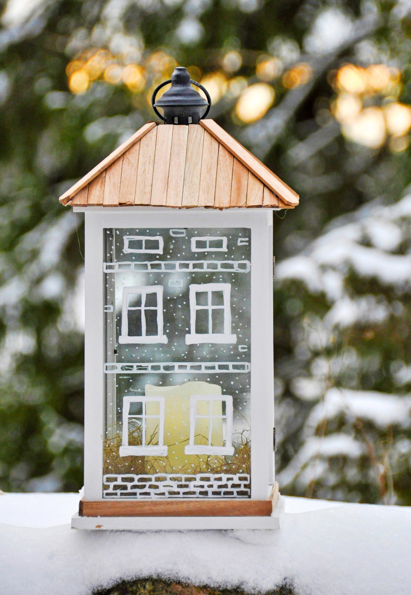 Light-up house in a lantern