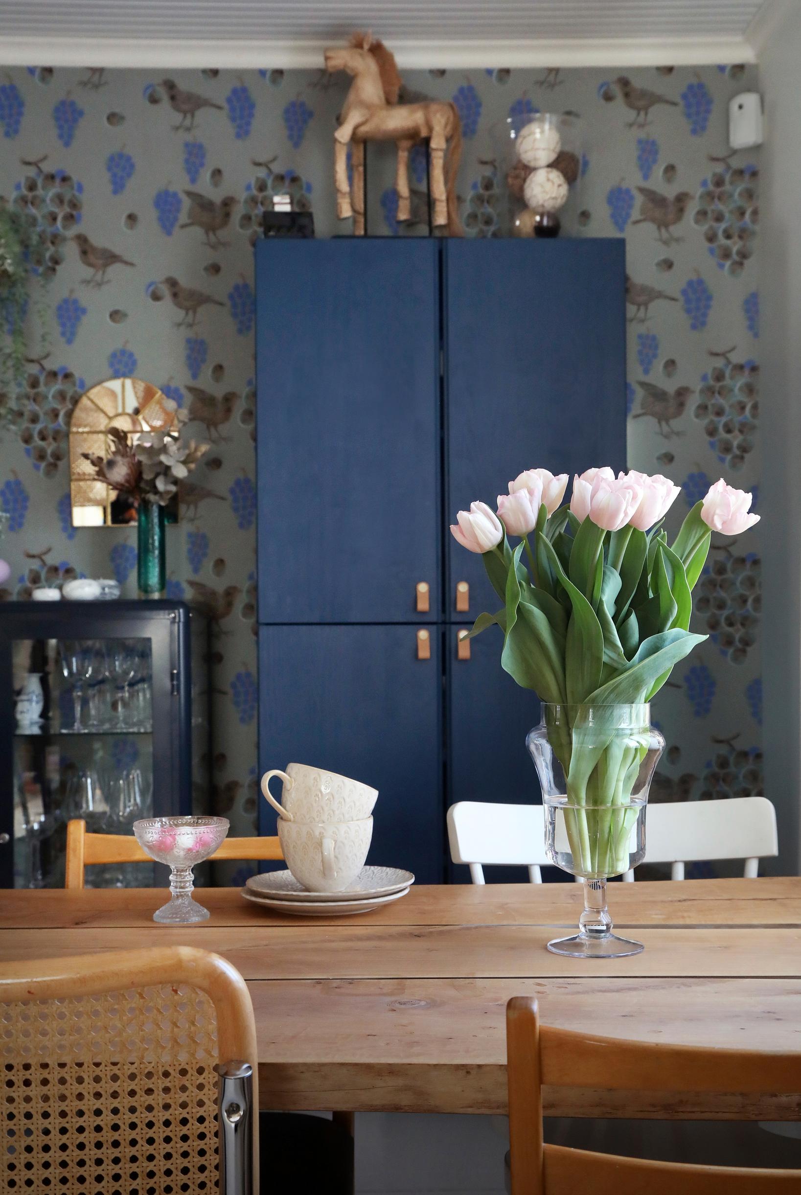 Two cabinets stacked on top of each other, painted in dark blue.