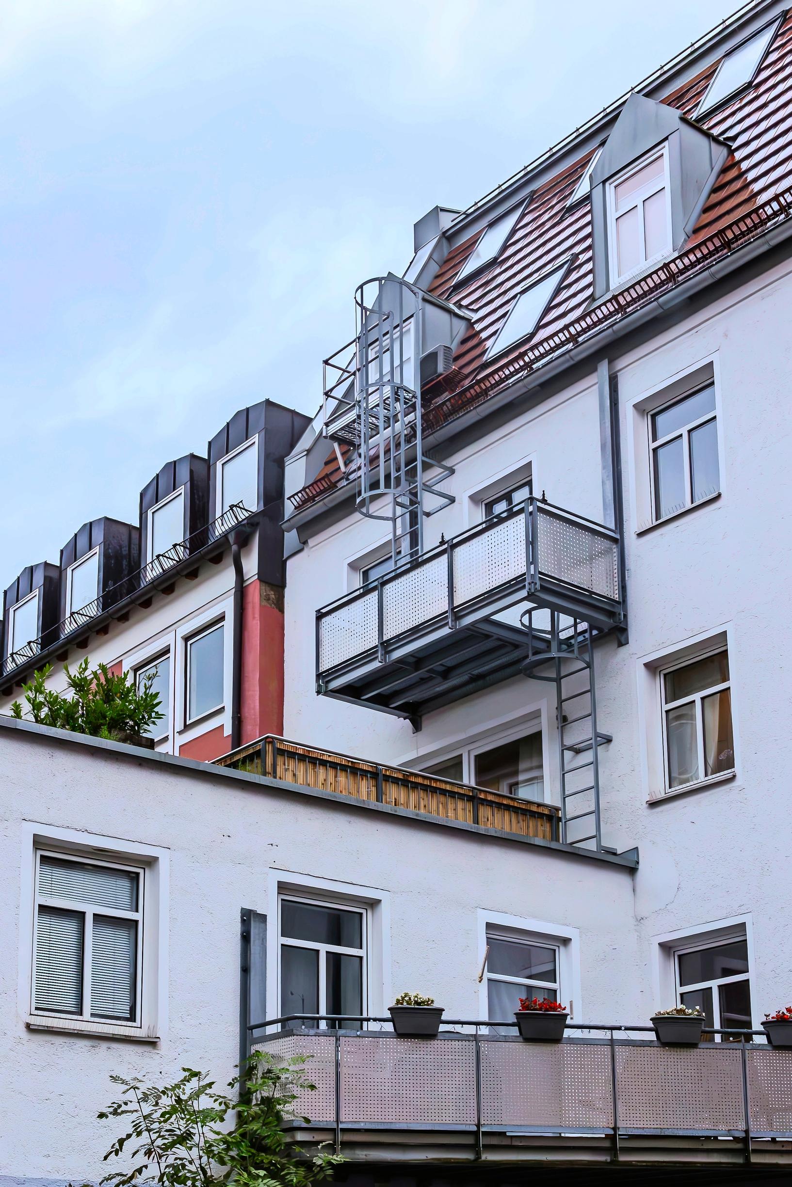 The family's large balcony extends from the old building's facade.
