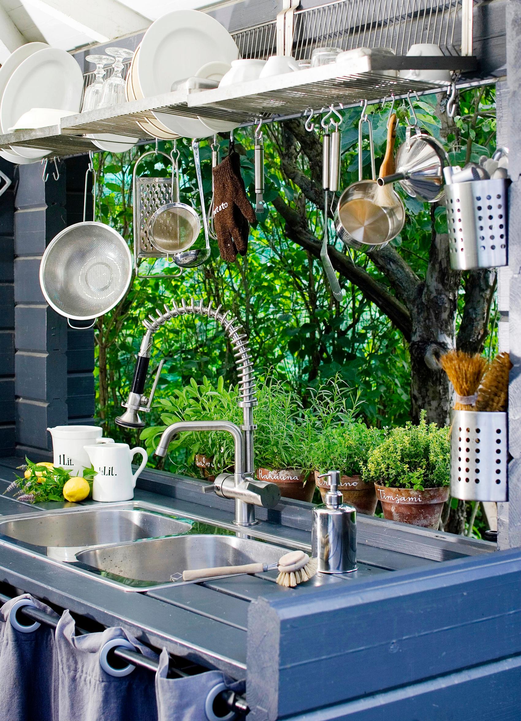 A well-equipped summer kitchen with creative storage solutions
