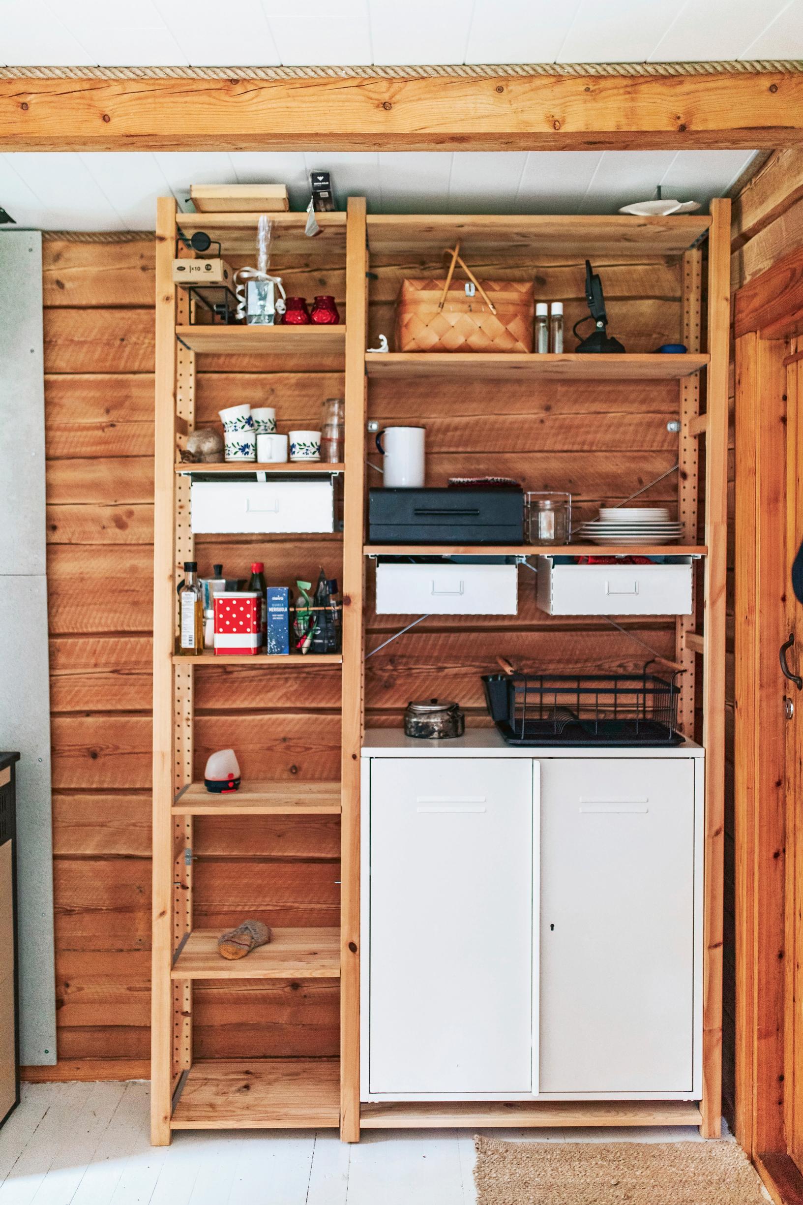 A wooden shelf unit in the log cottage.