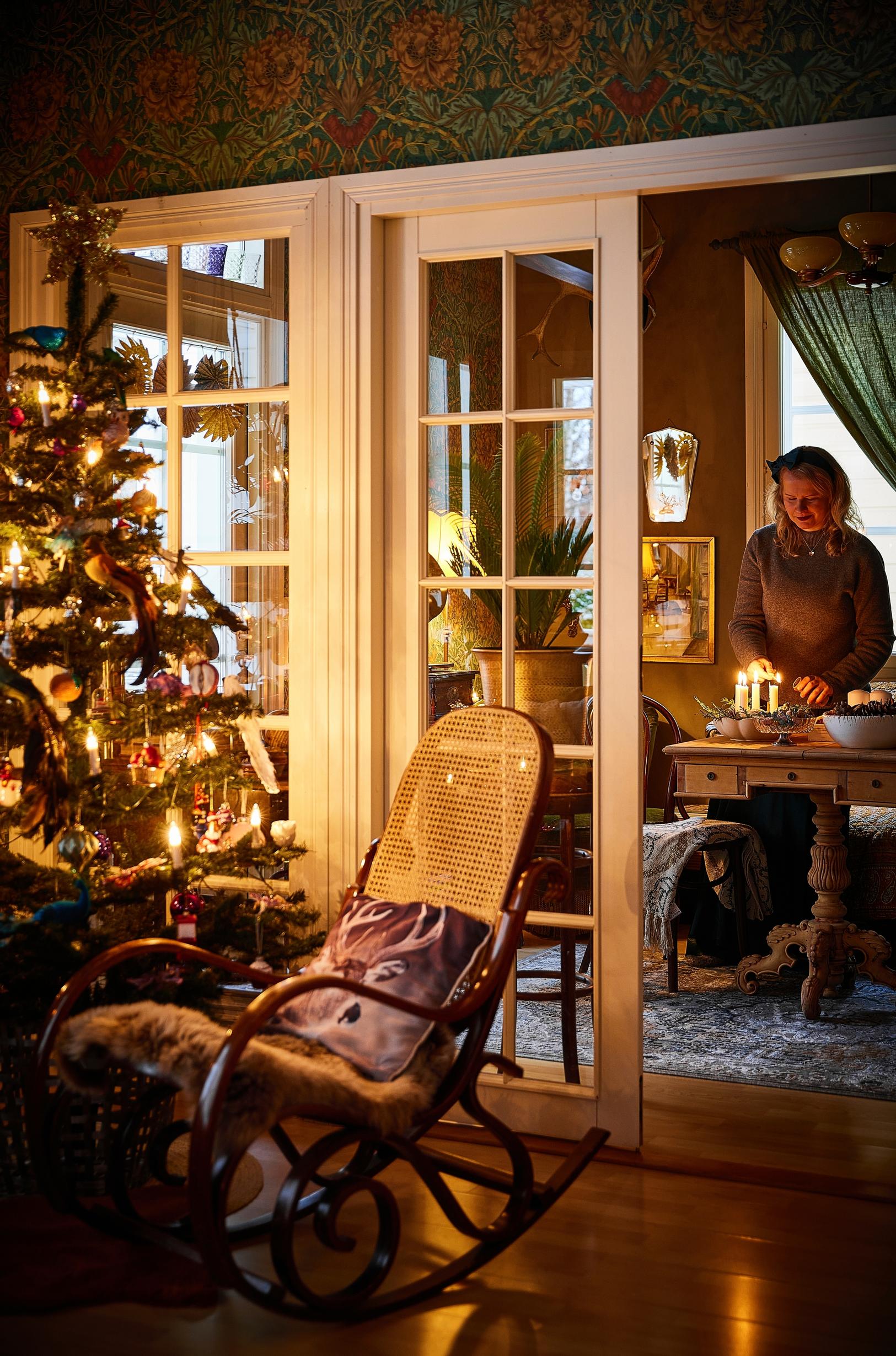 A rocking chair by the Christmas tree.