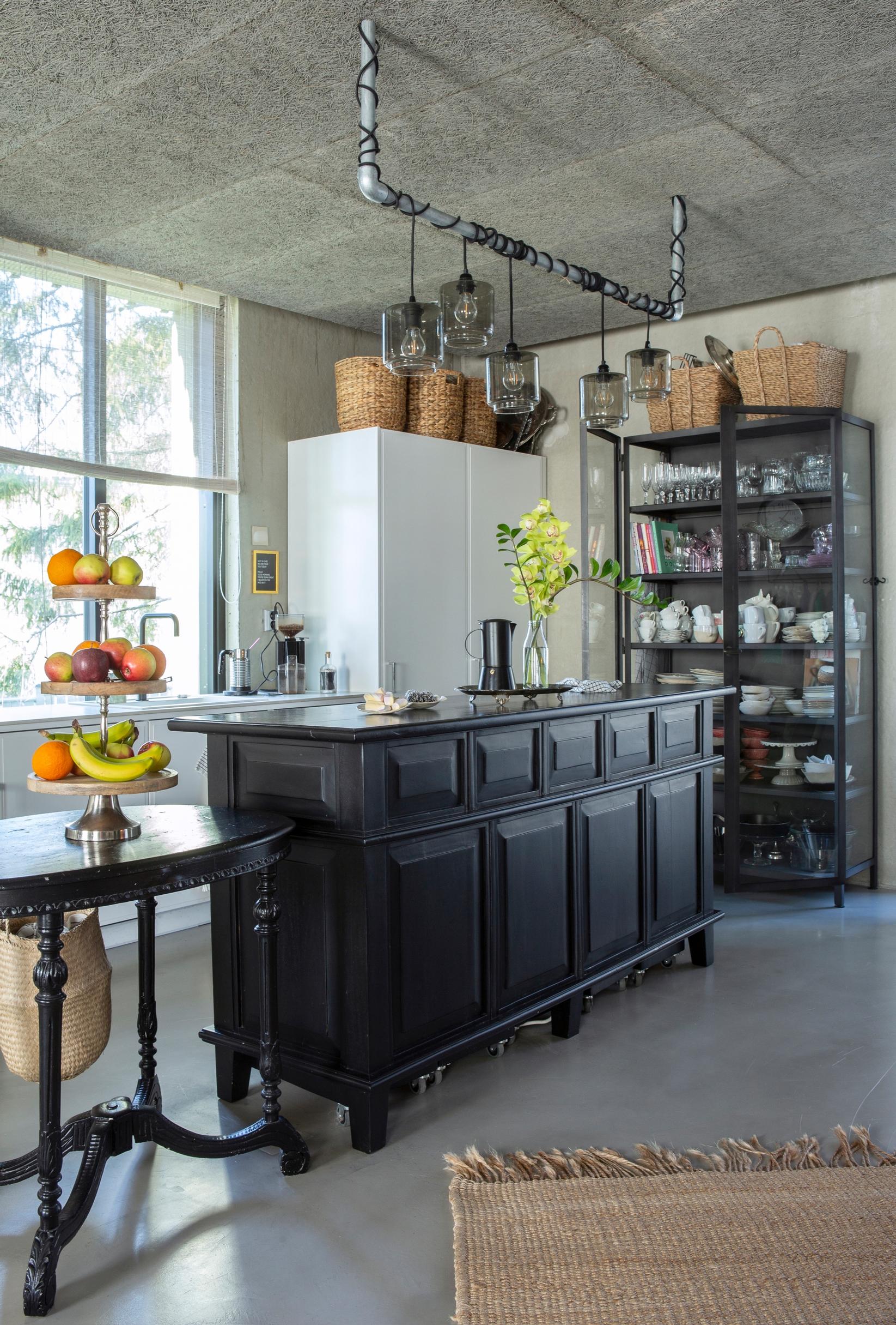 An old wooden store counter with drawers, repurposed as a kitchen island.
