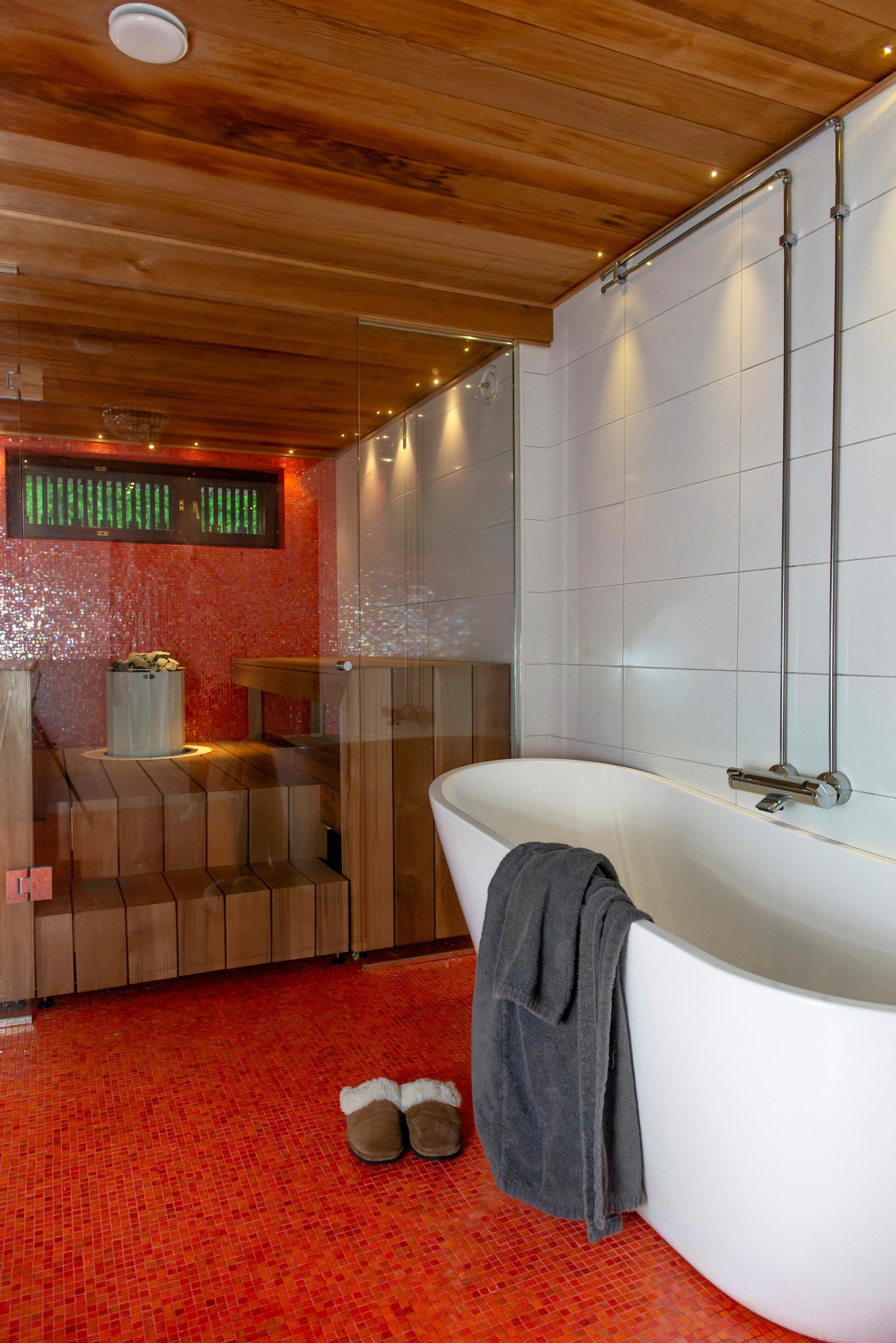 Image of a rowhouse bathroom with a red mosaic floor.