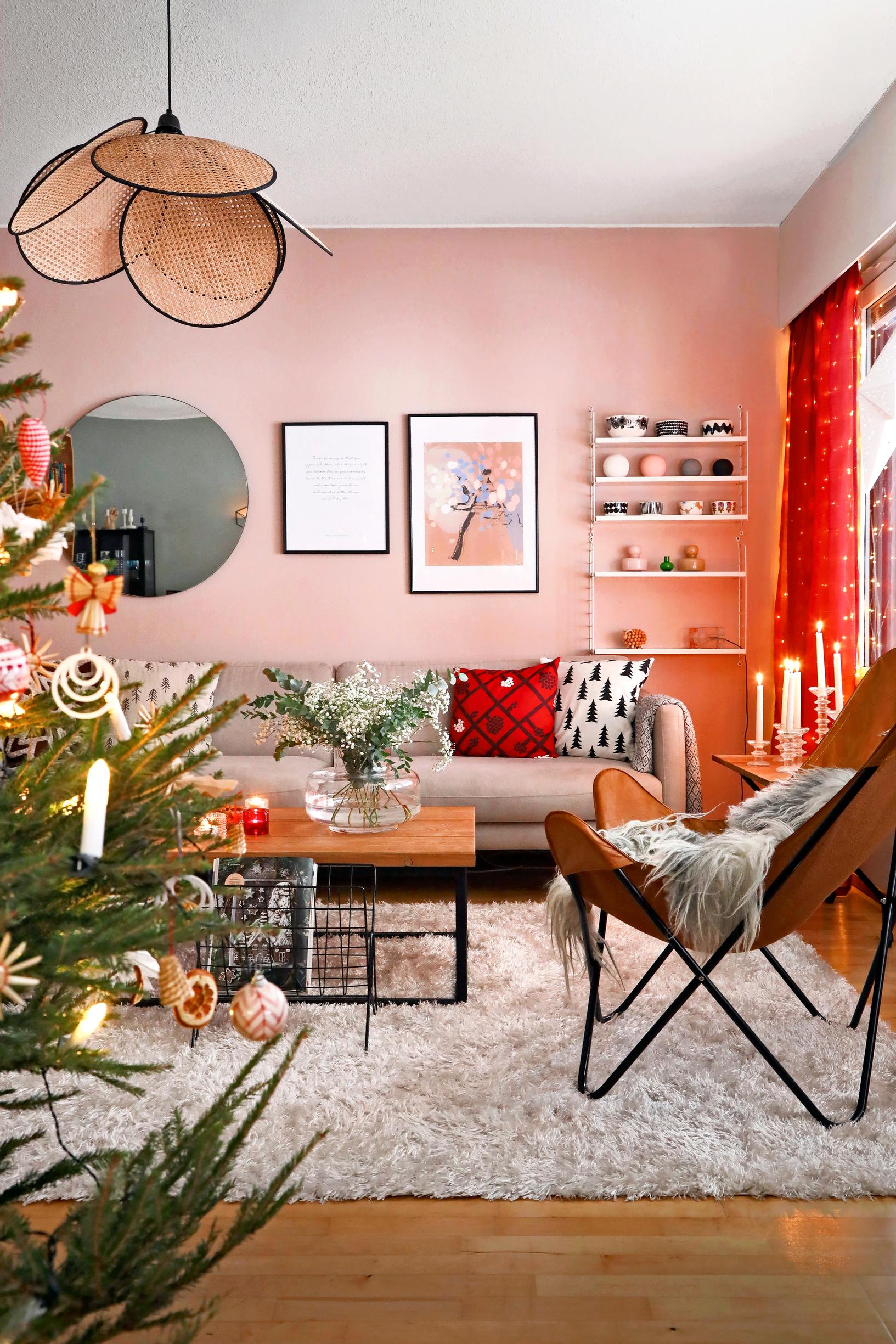 A pink-toned living room with a Christmas tree