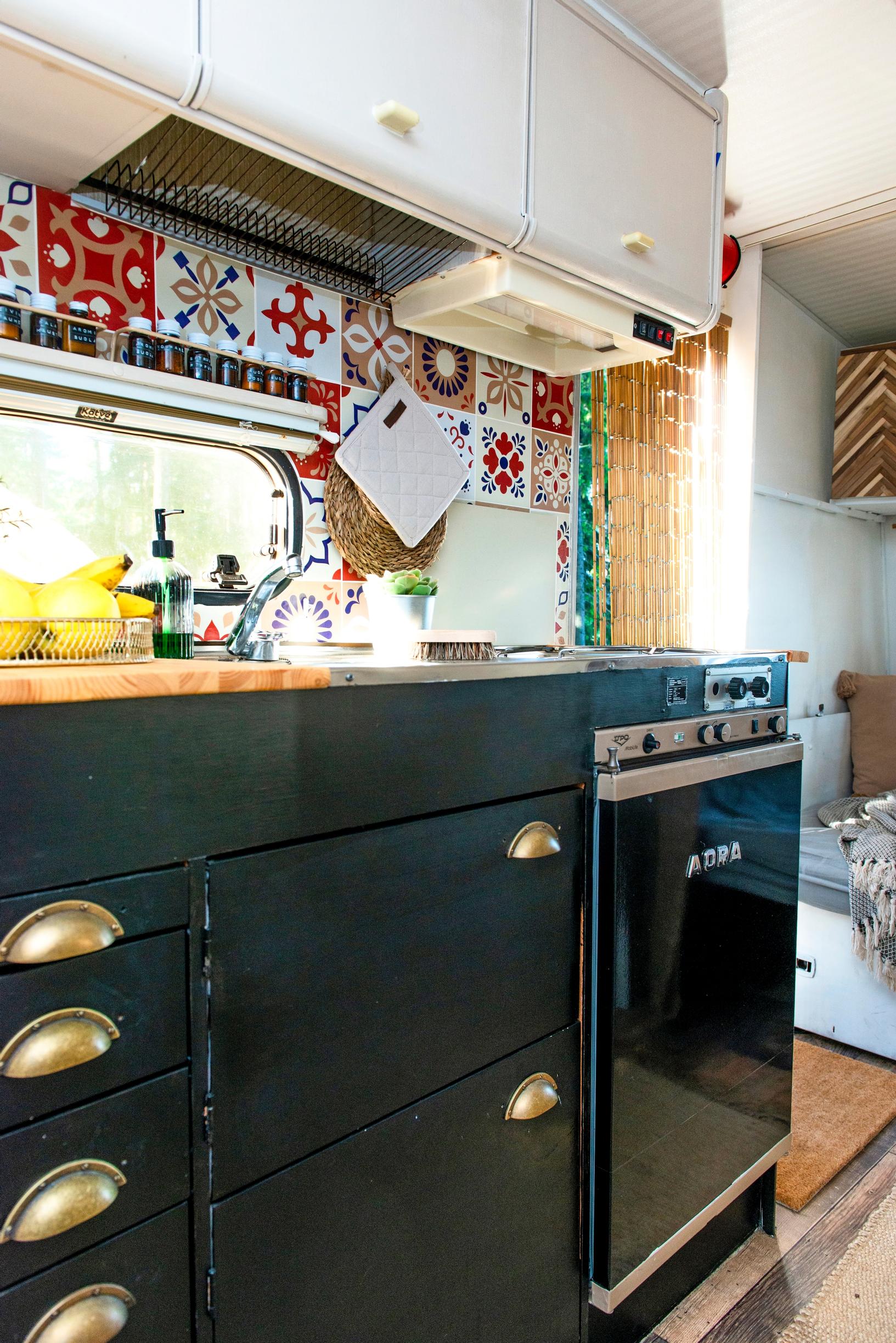 travel trailer kitchen with black cabinet doors