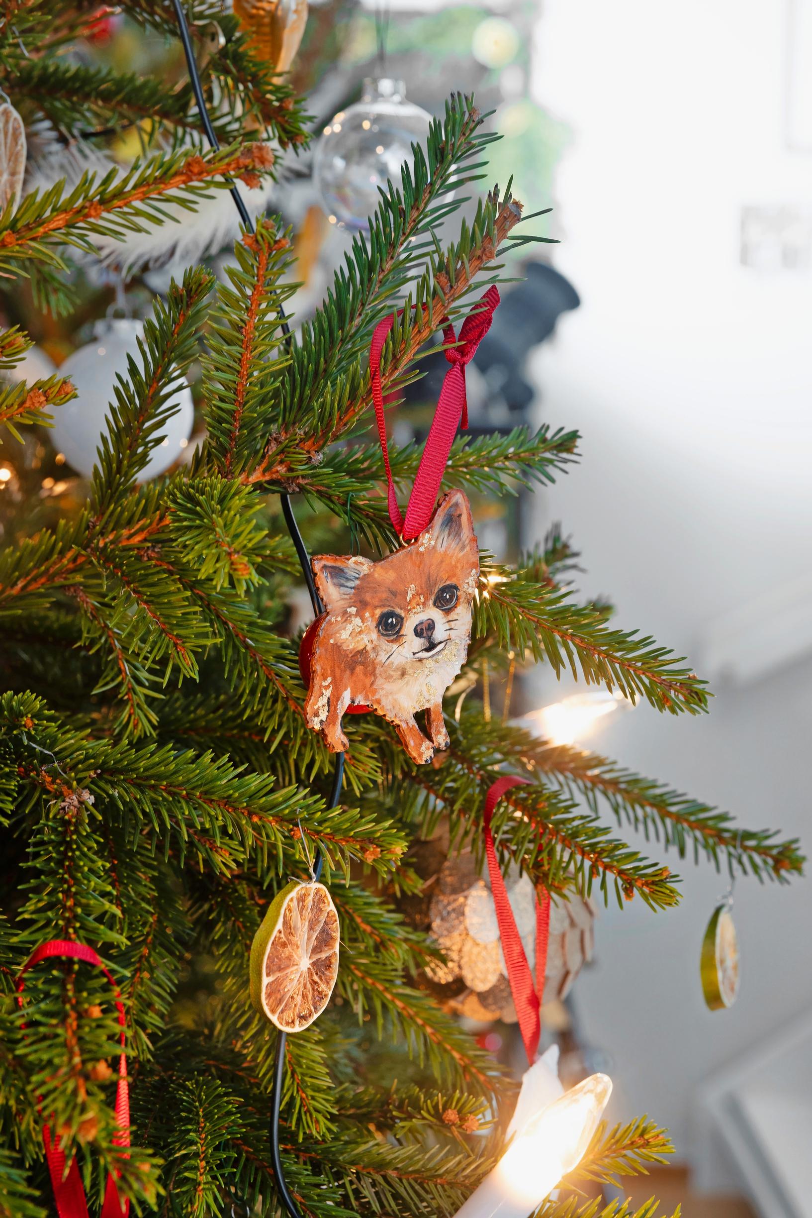 A dog ornament on a Christmas tree.