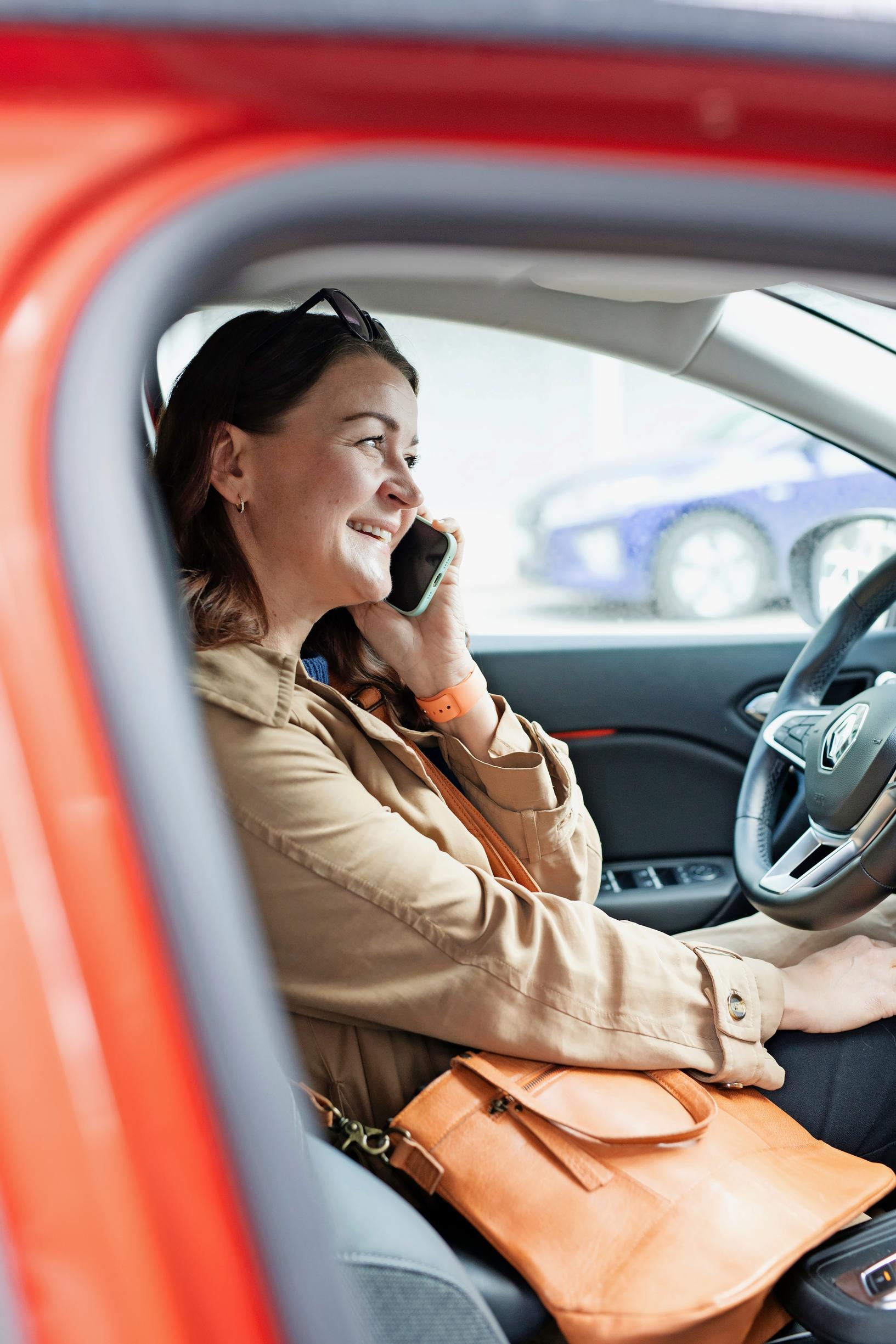 Woman talking on the phone in a car
