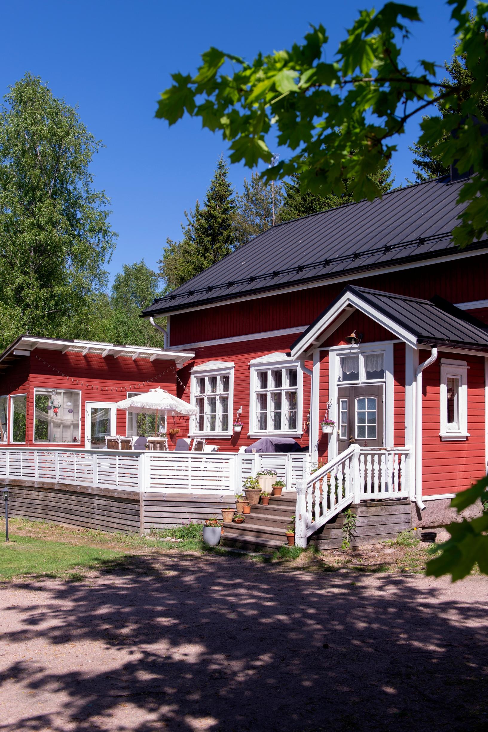 Red village school with a terrace in front