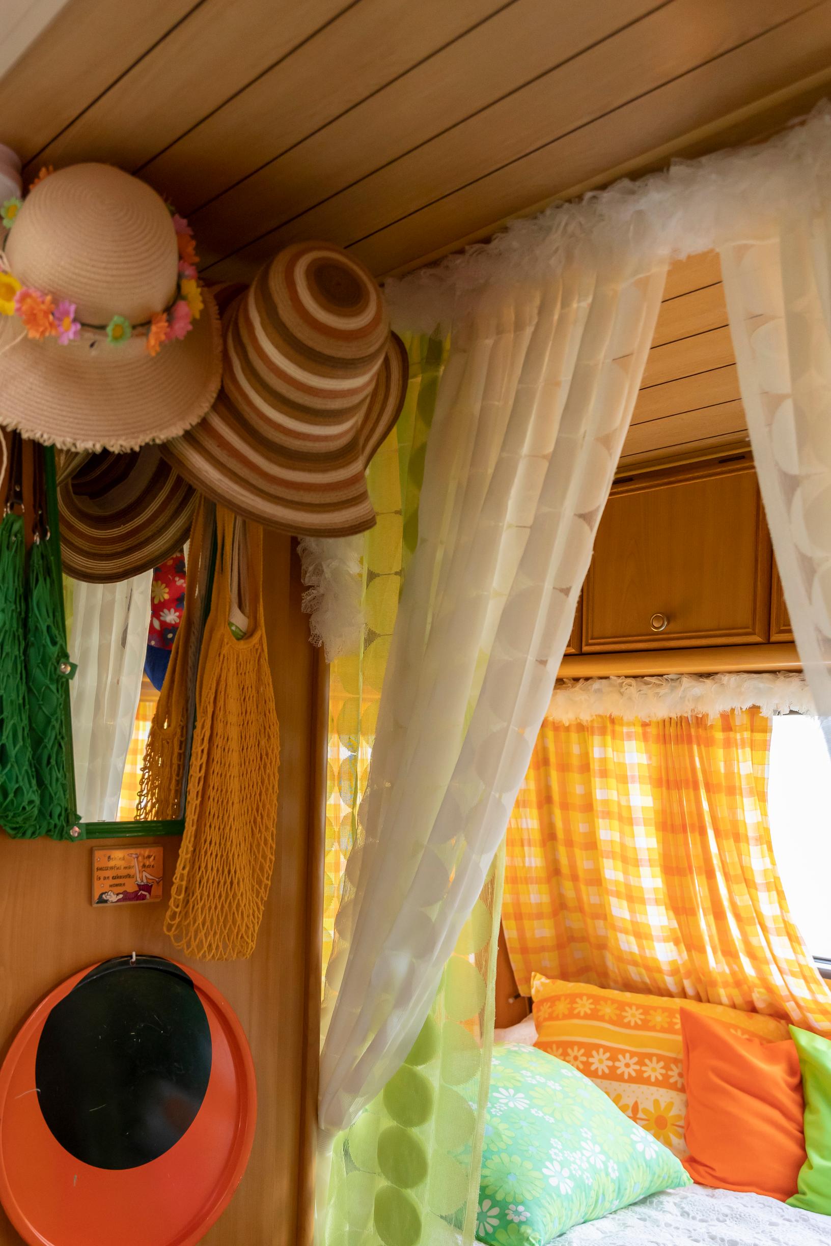 hats on the wall and a sofa nook in the travel trailer