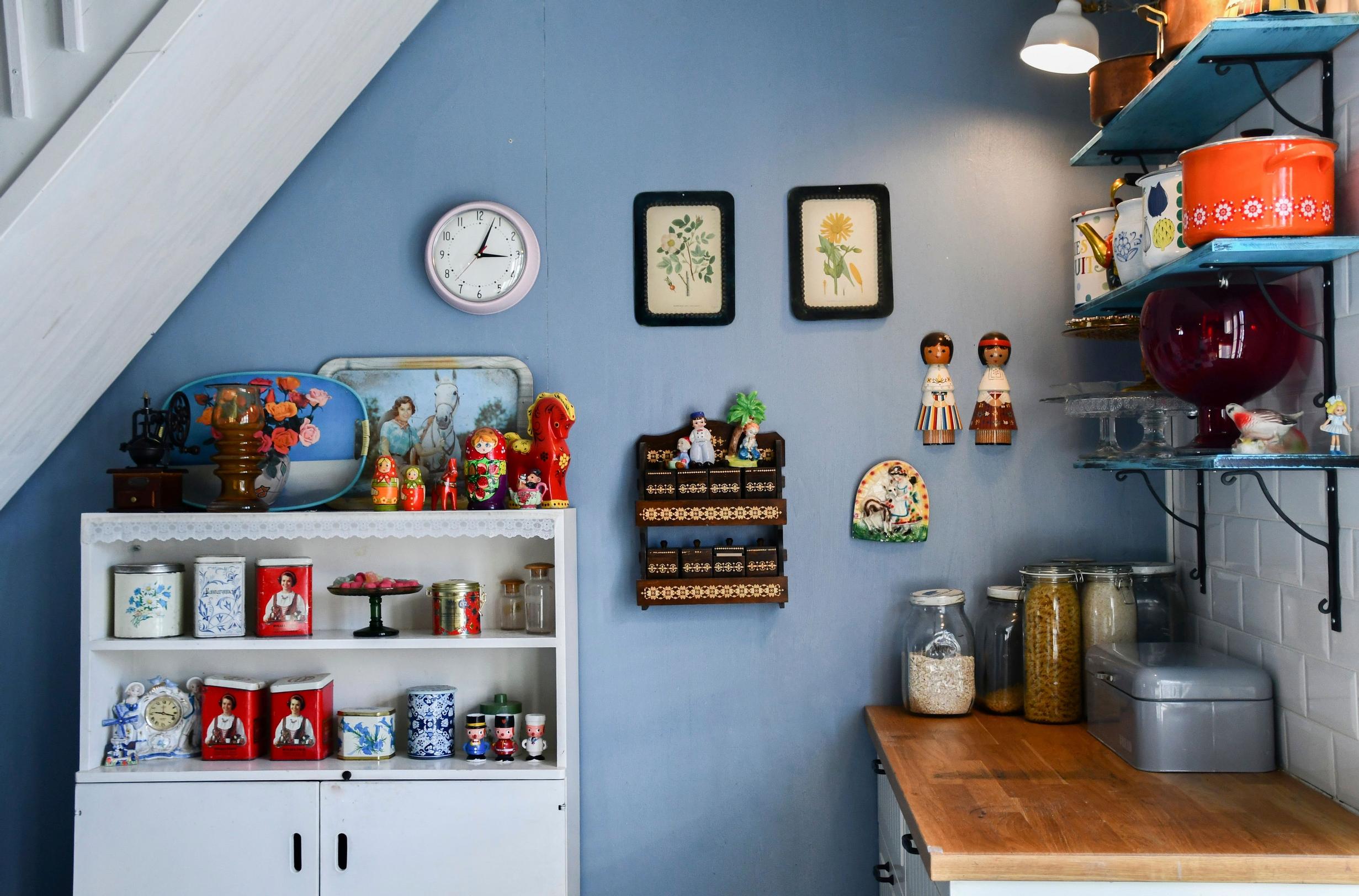 Open shelving in the kitchen and a wall painted blue.