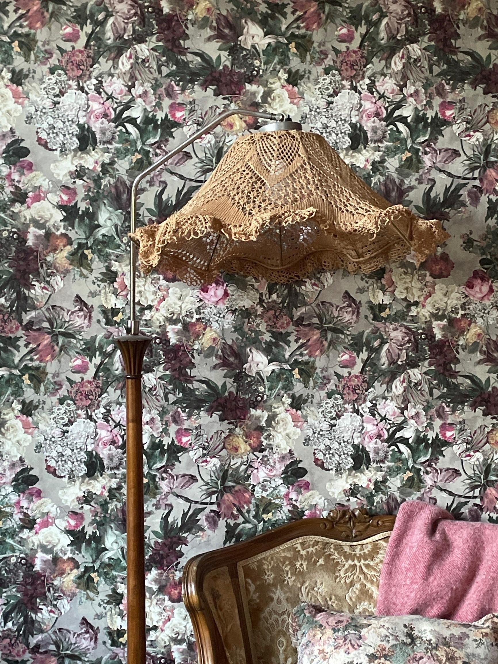 A lace doily used as a floor lamp shade.
