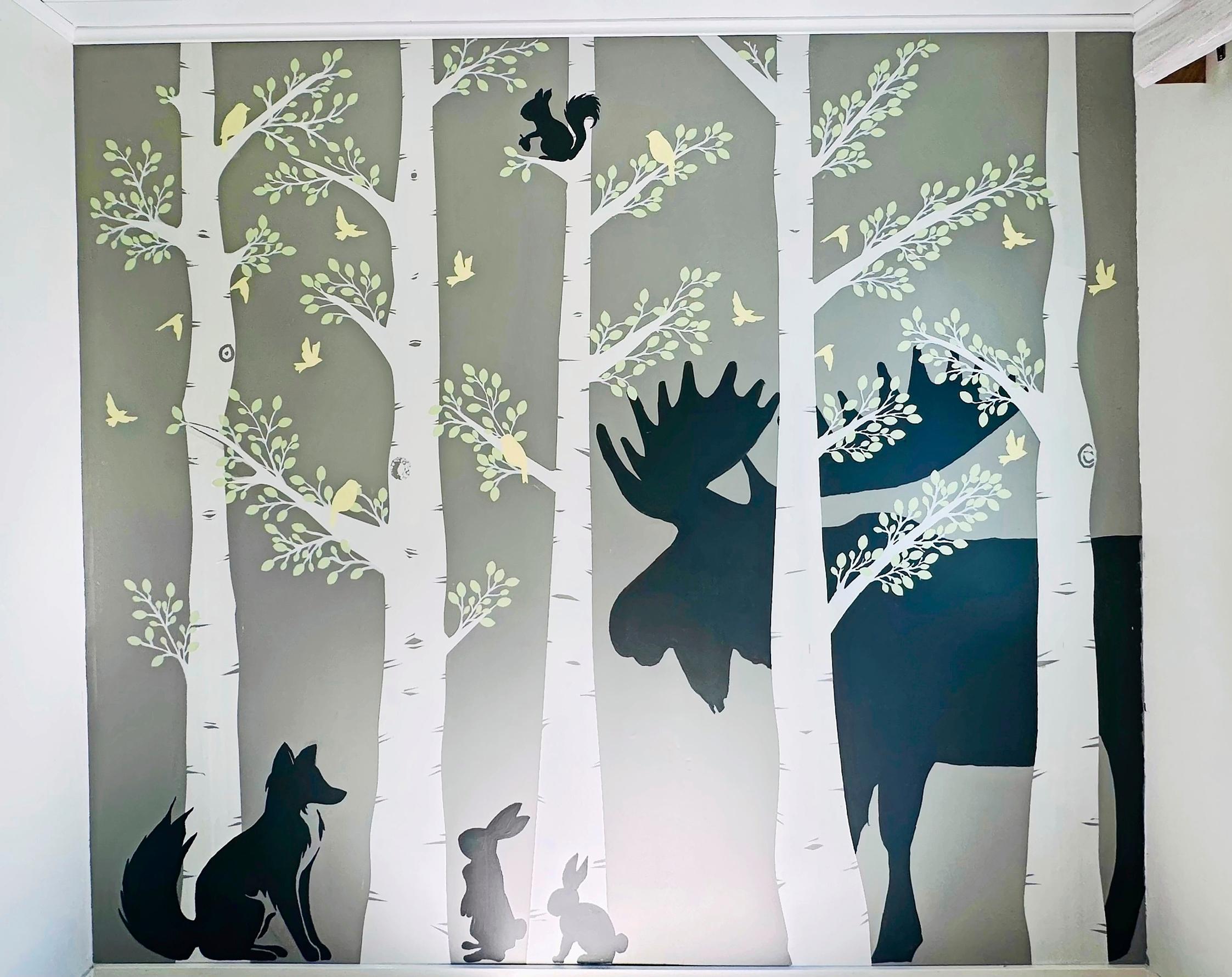 In the mural, the animals are nestled among birch trees.
