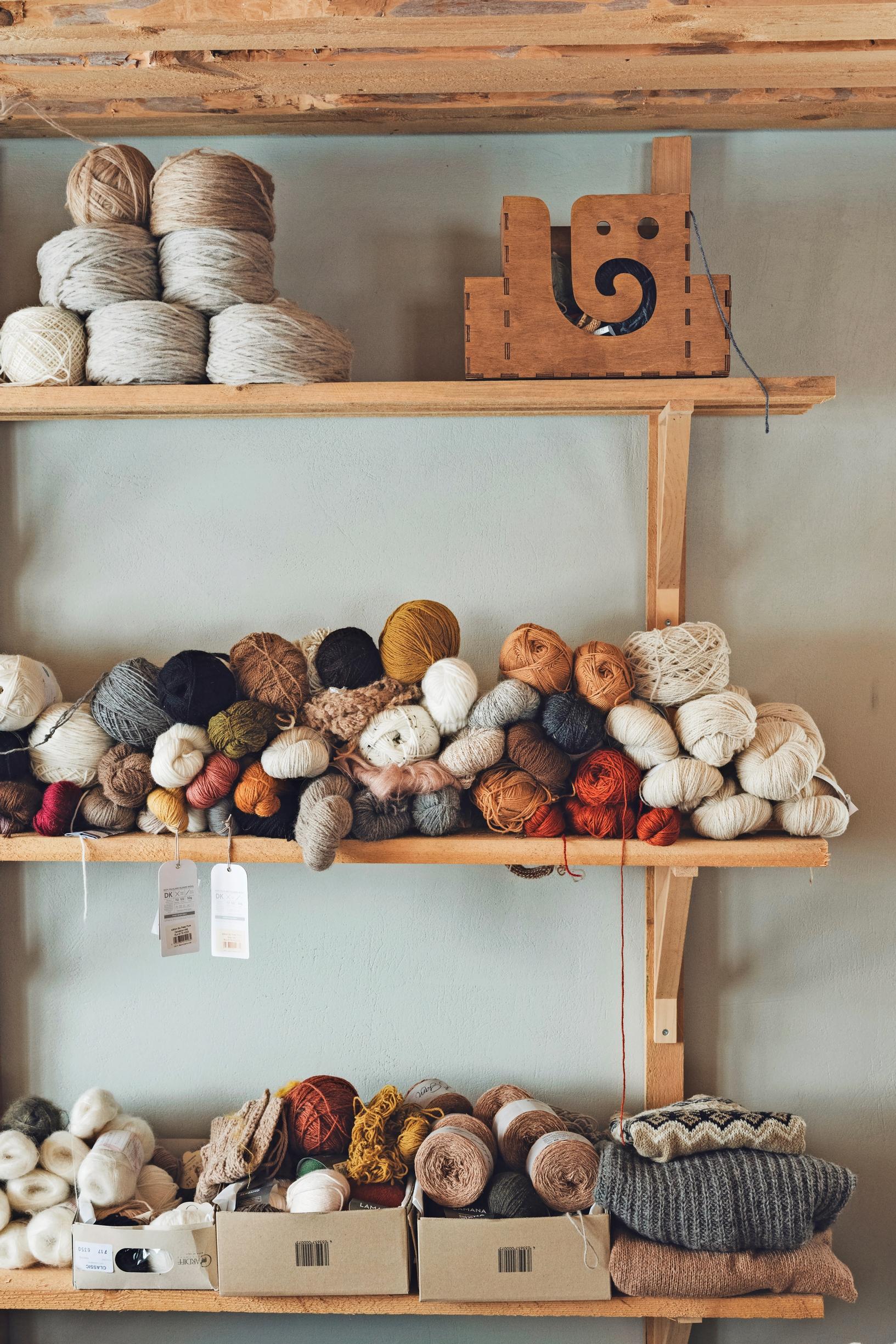Skeins of wool on a shelf.