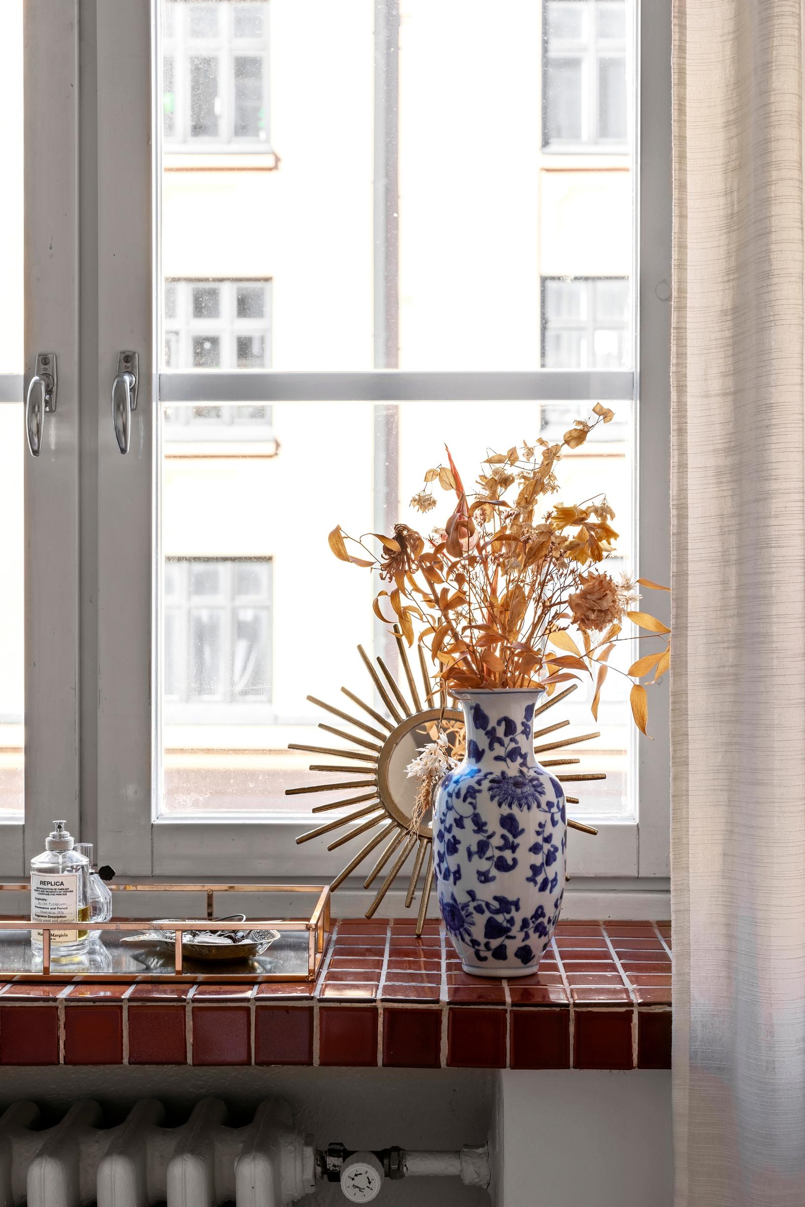 A flower vase on the windowsill