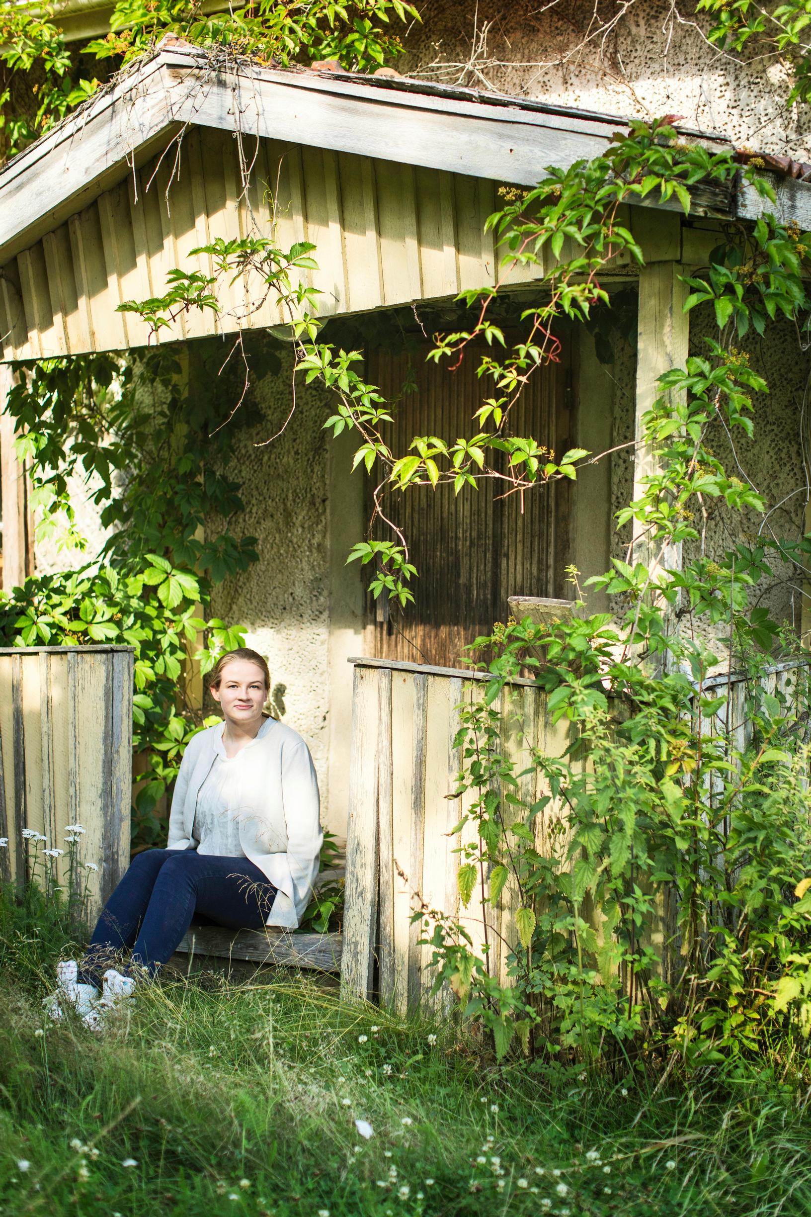 Beekeeper Nora on the steps of the old gardener’s cottage