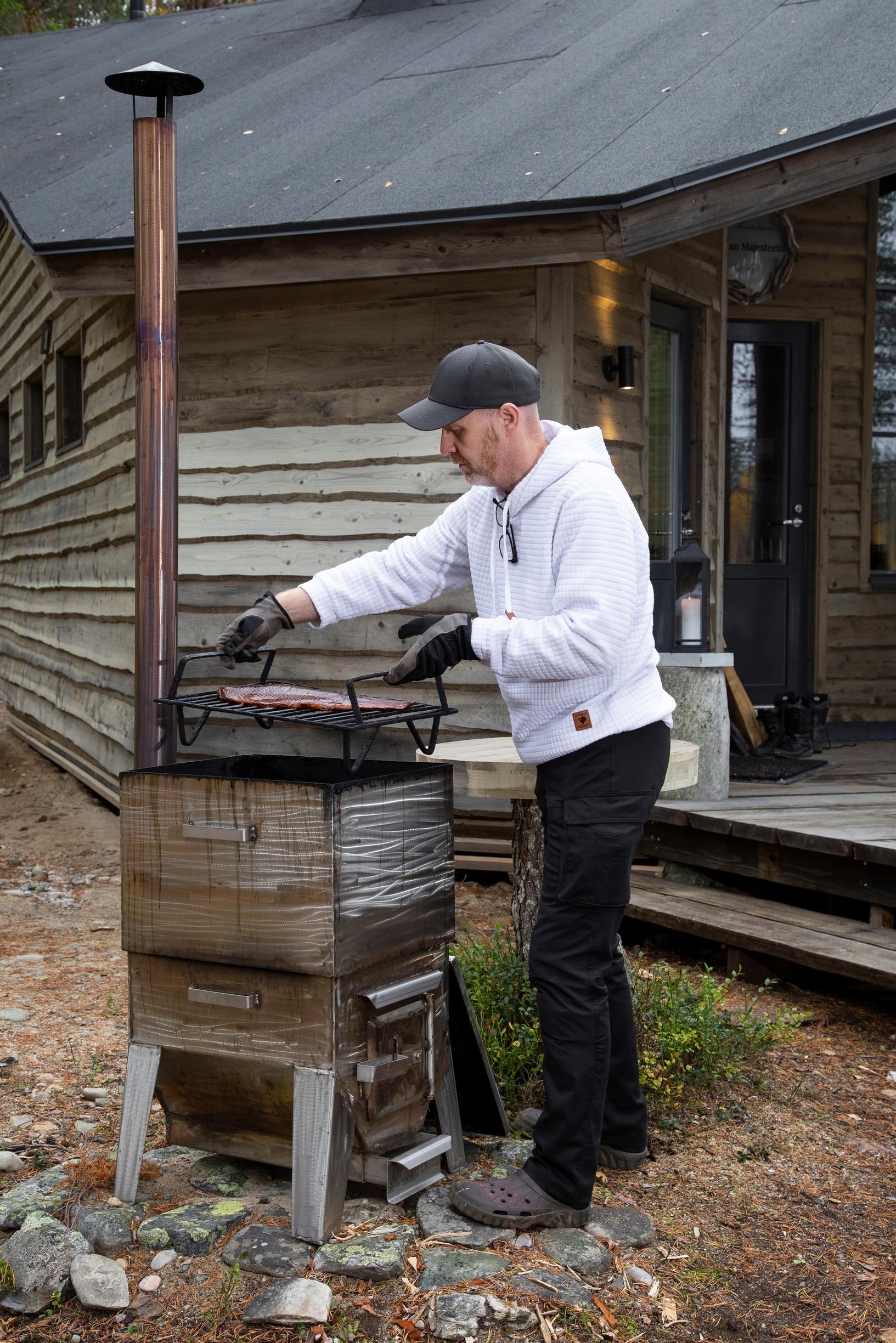 Jukka smoking salmon in the cabin’s yard