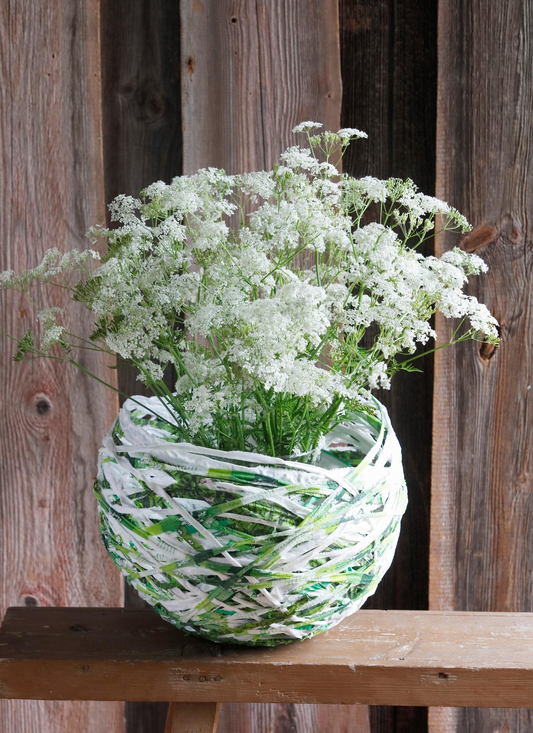A finished bowl with cow parsley in a glass jar
