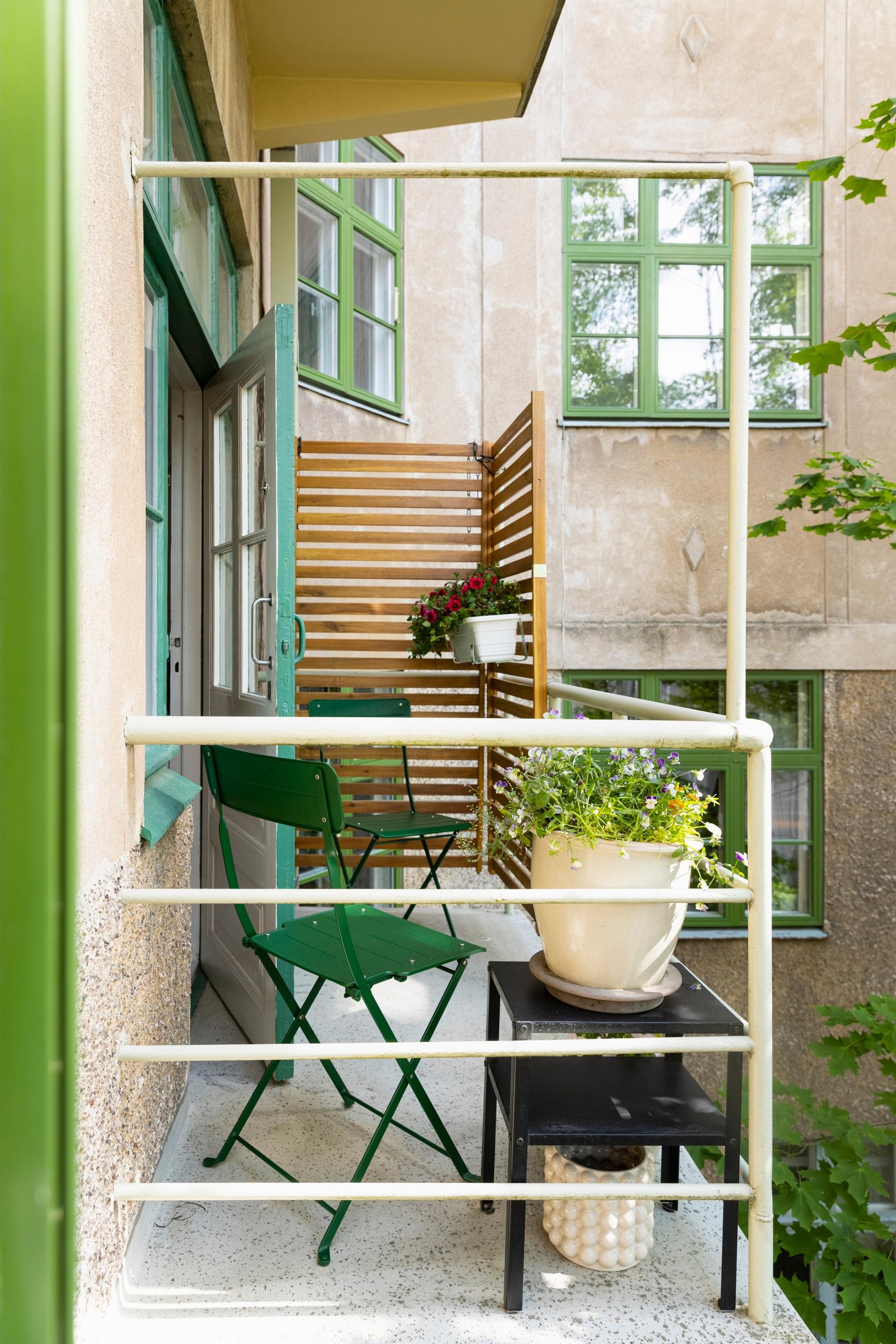 A small balcony on the back side of the building