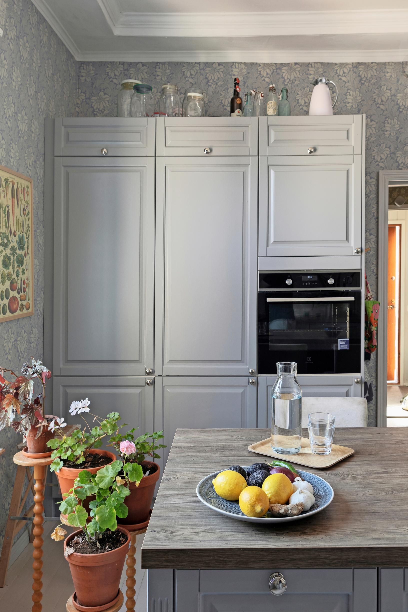 A photo of the kitchen with a vintage feel, featuring gray cabinets.