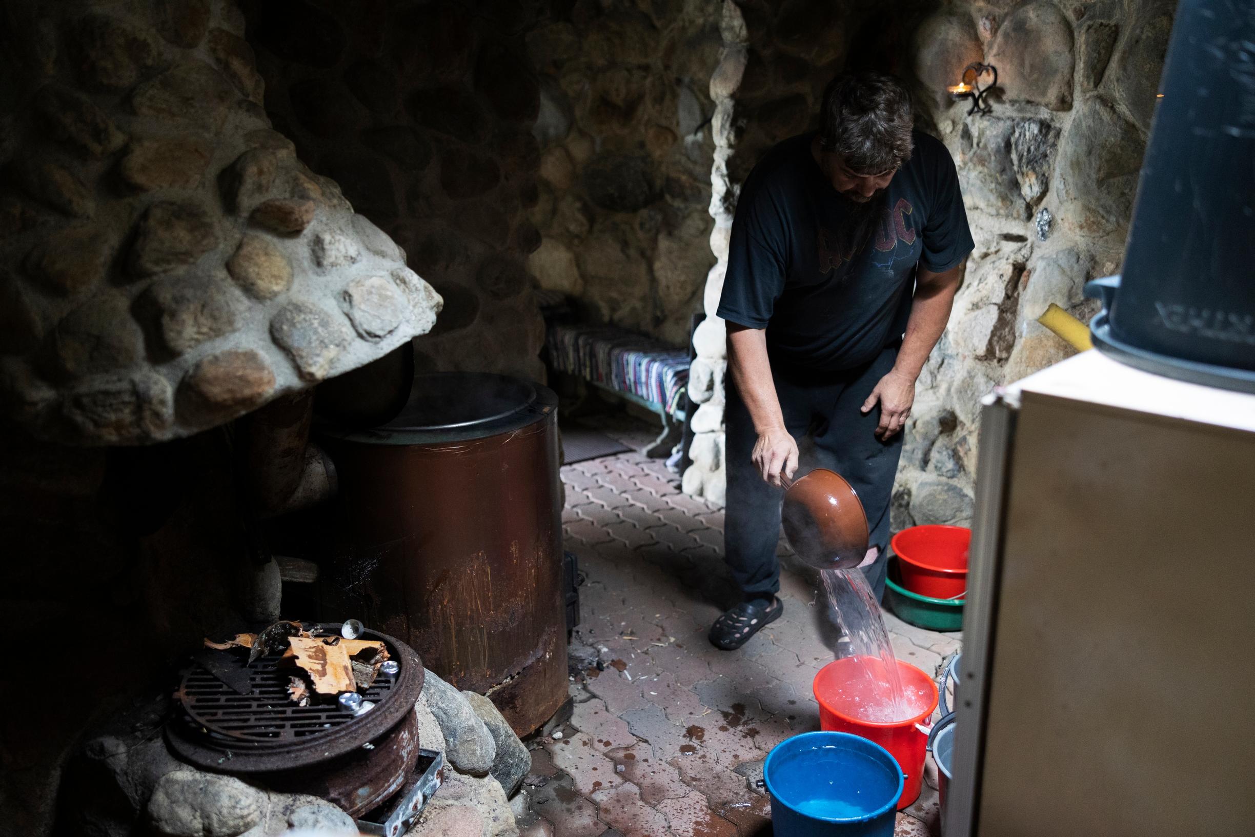 Tending to the water inside the sauna
