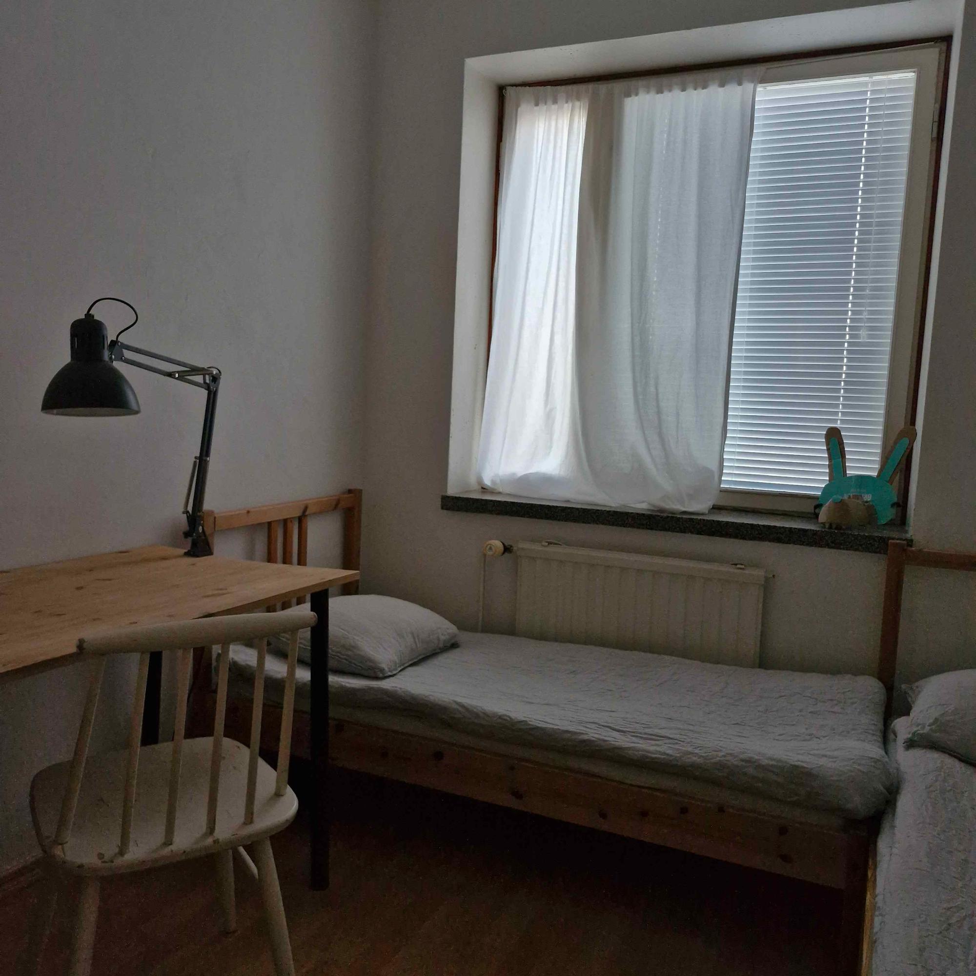 children’s room with two beds and a desk