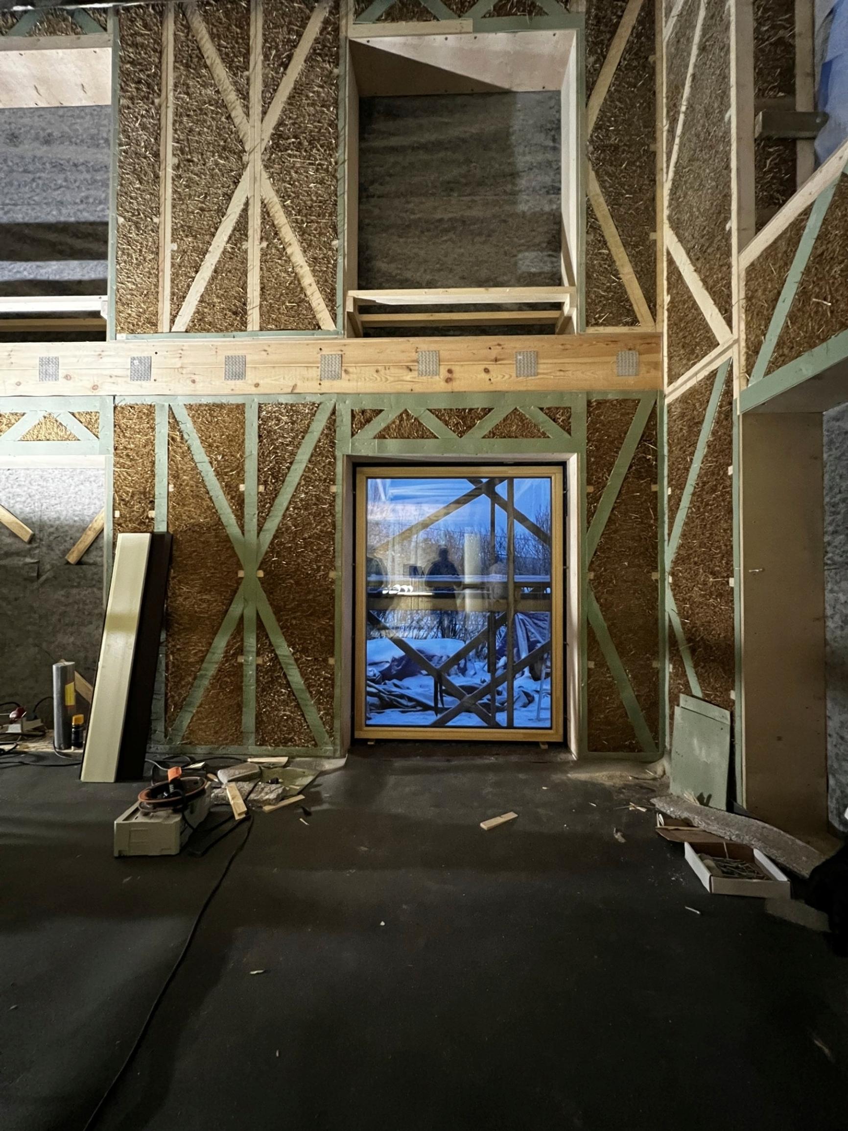 Erected straw elements with wooden frames on the construction site