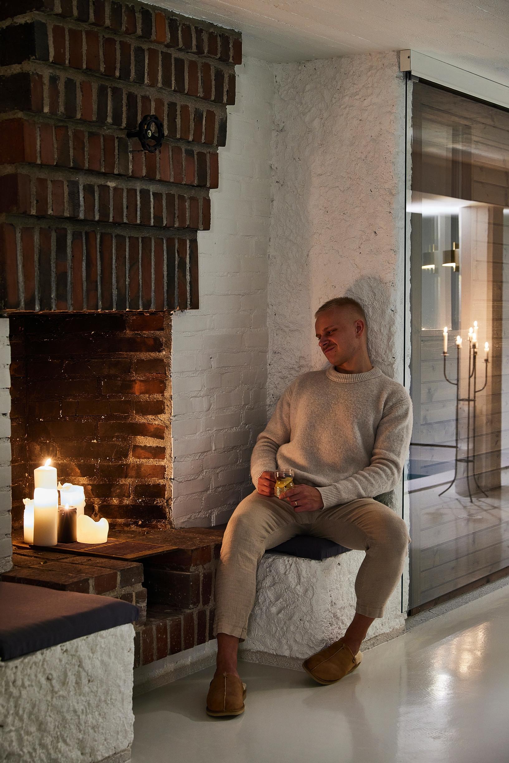 Aleksi by the fireplace in the pool area.