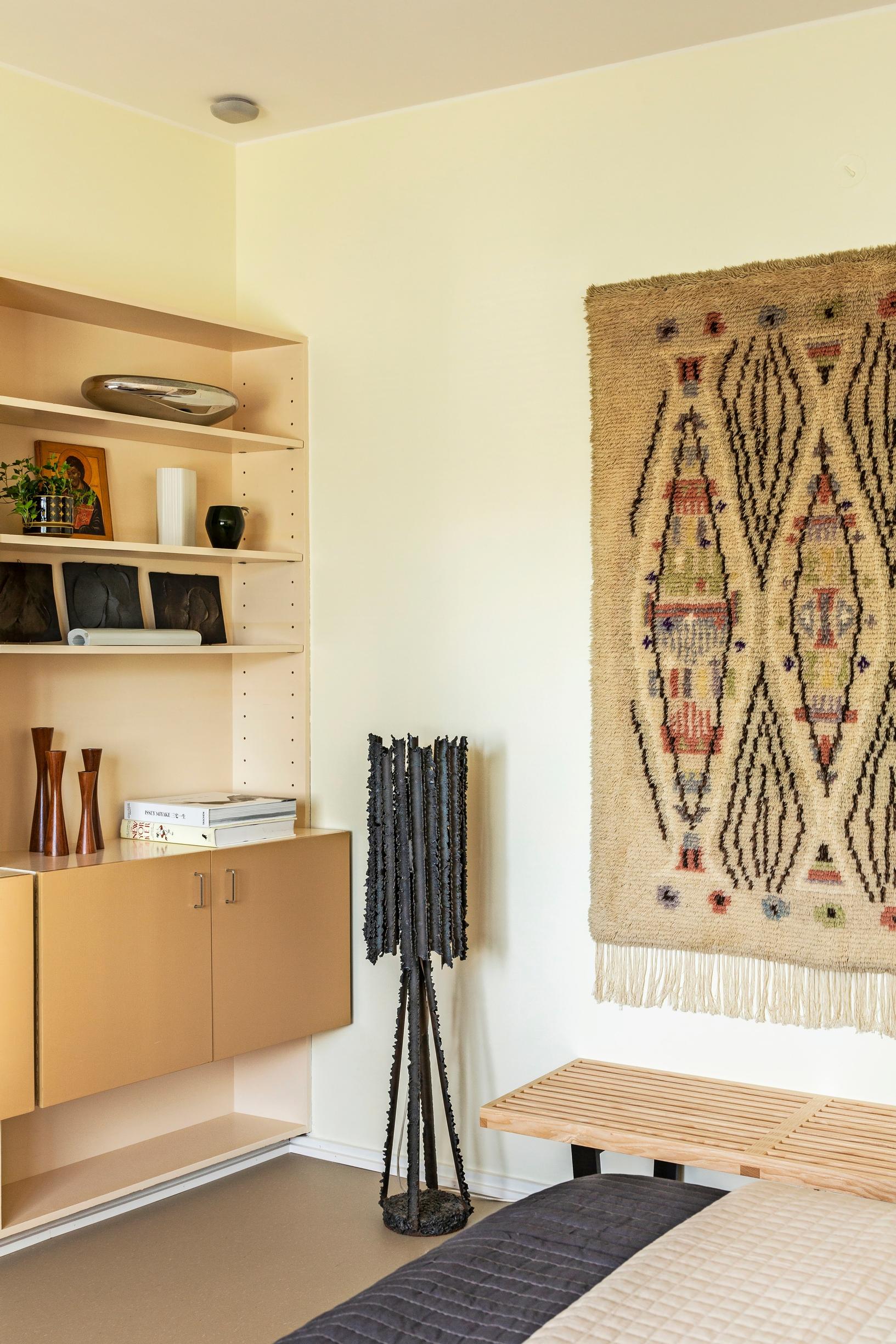 In the guest room, a built-in 1960s bookshelf and a rya