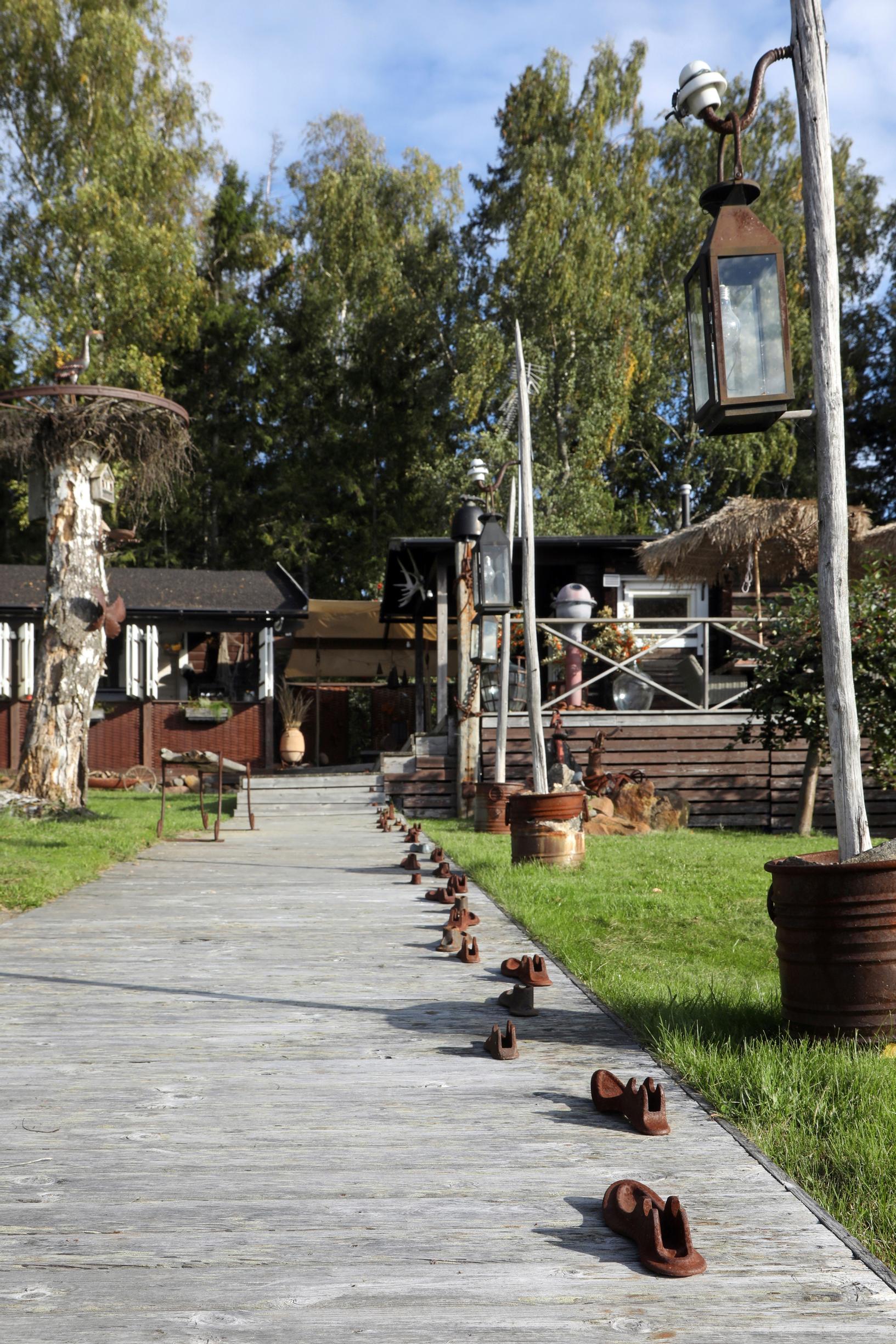 Hay poles along the wooden walkway leading to the cabin.