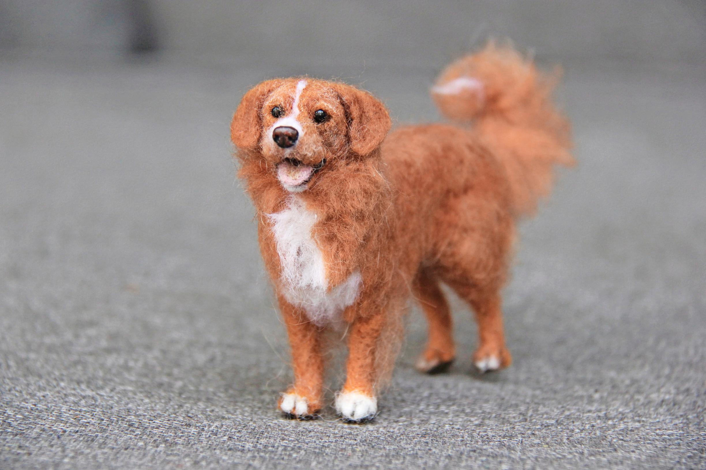A miniature felted dog.