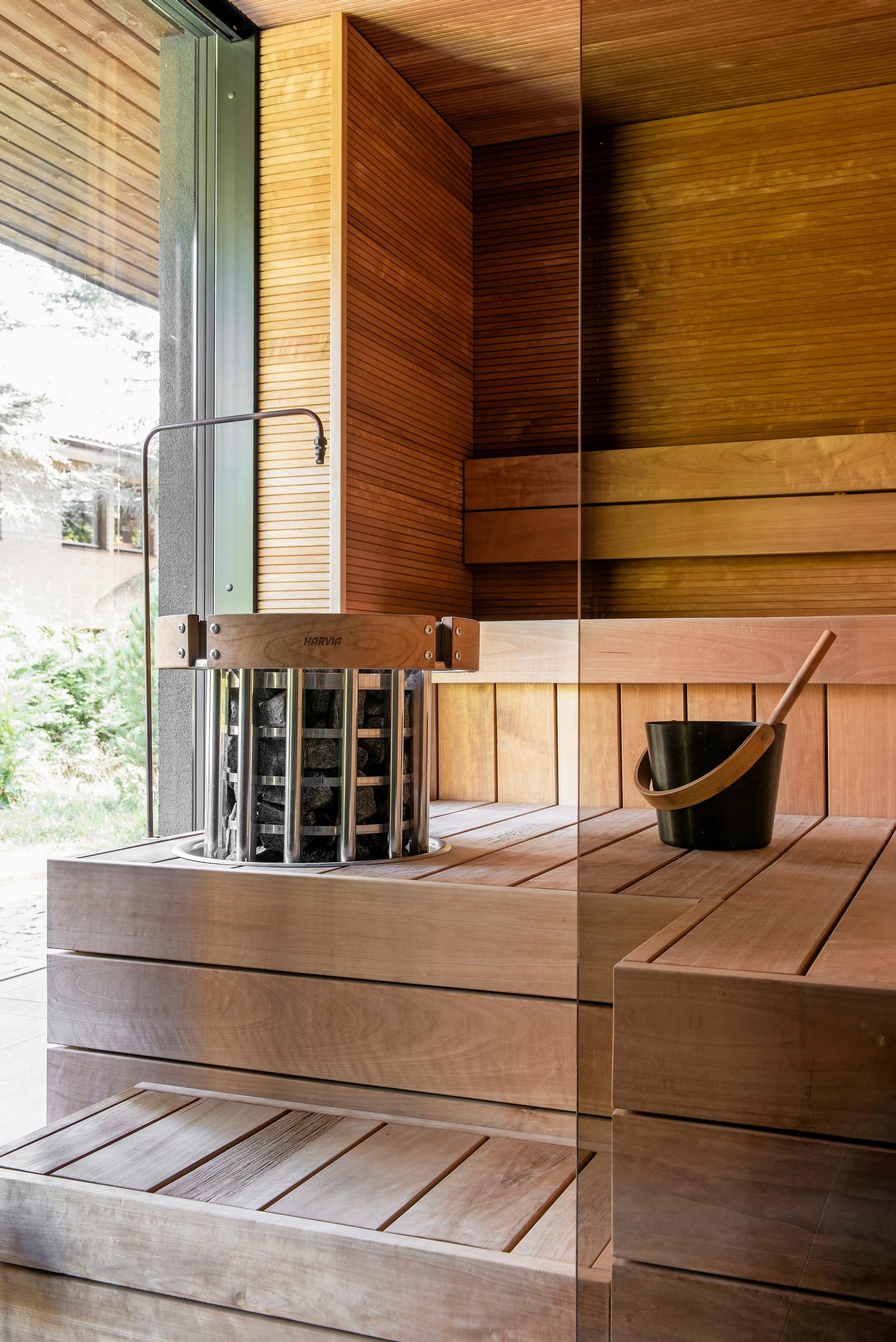 In the sauna, a steam automation device, with a view of the private backyard through the large window
