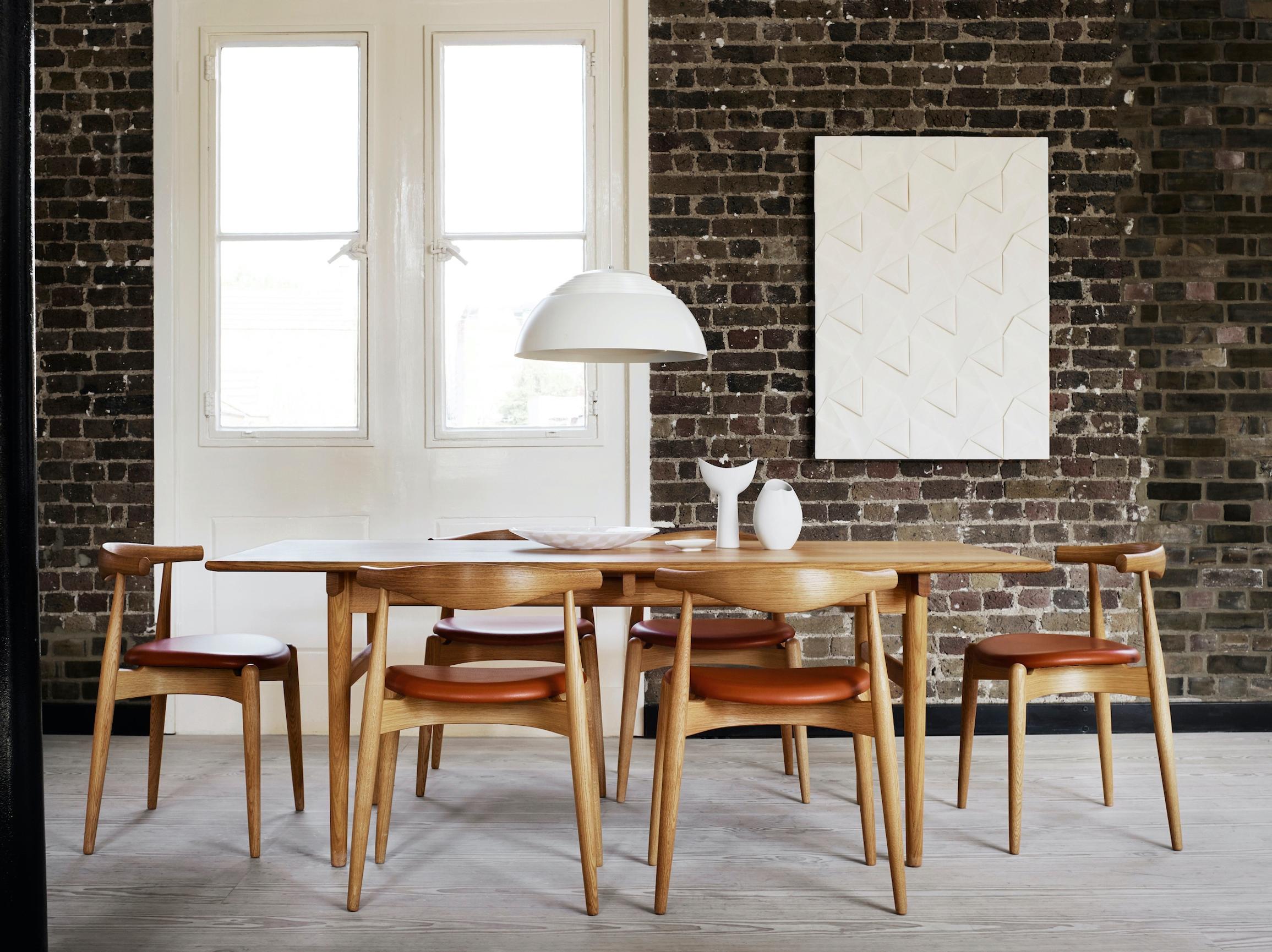 How high to hang art? A light piece against a brick wall