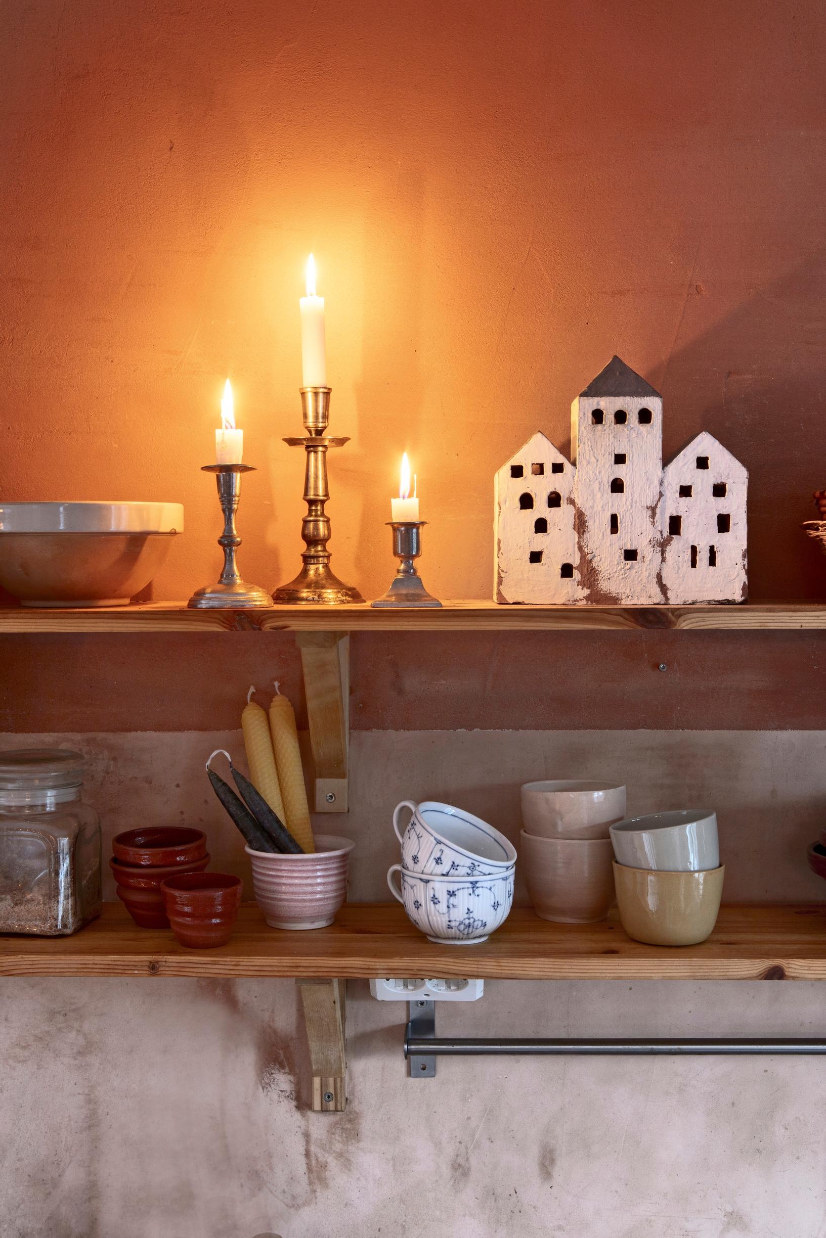 Open shelf with lit candles