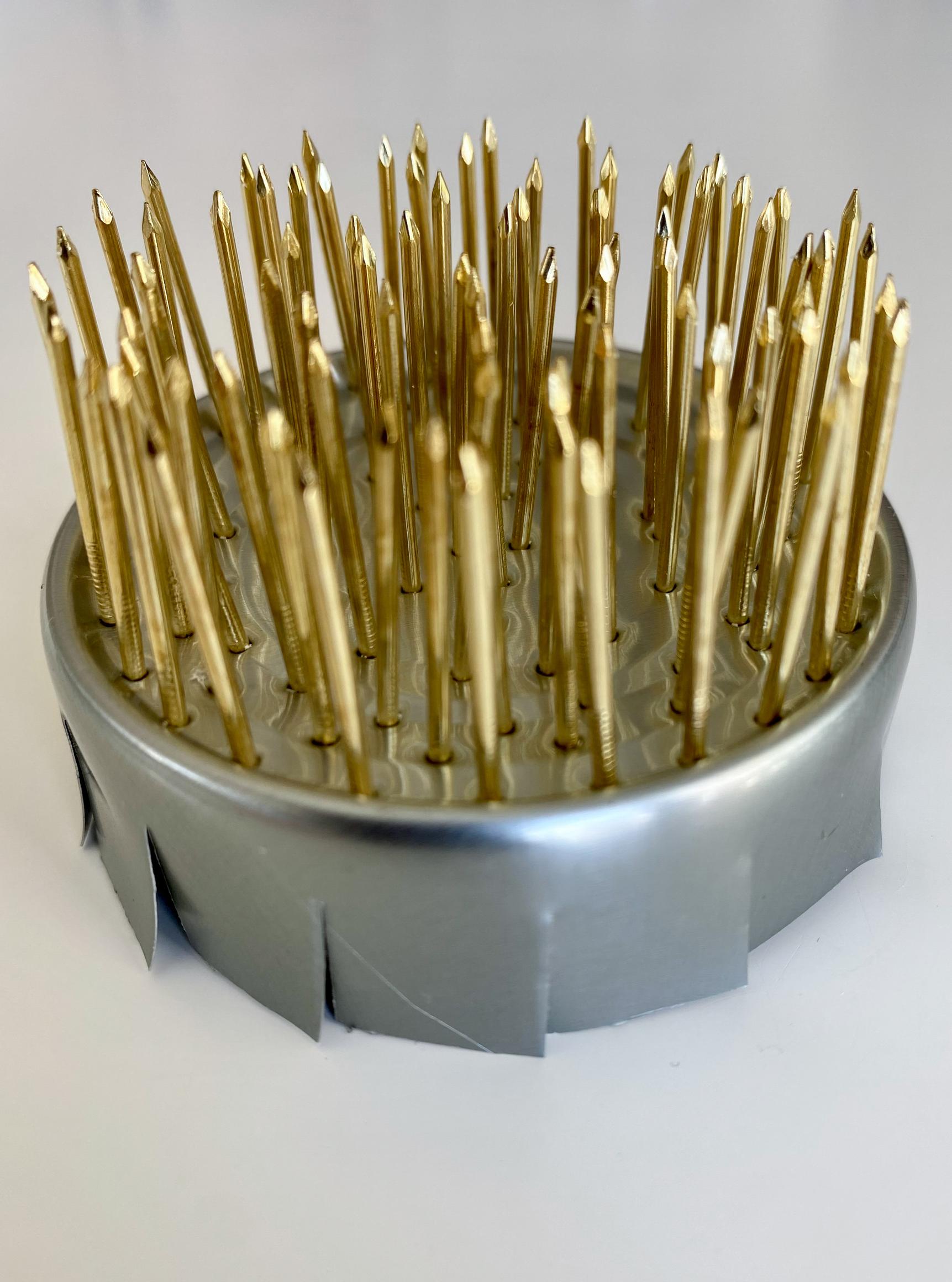 Cutting slits in the rim of the pin frog with scissors
