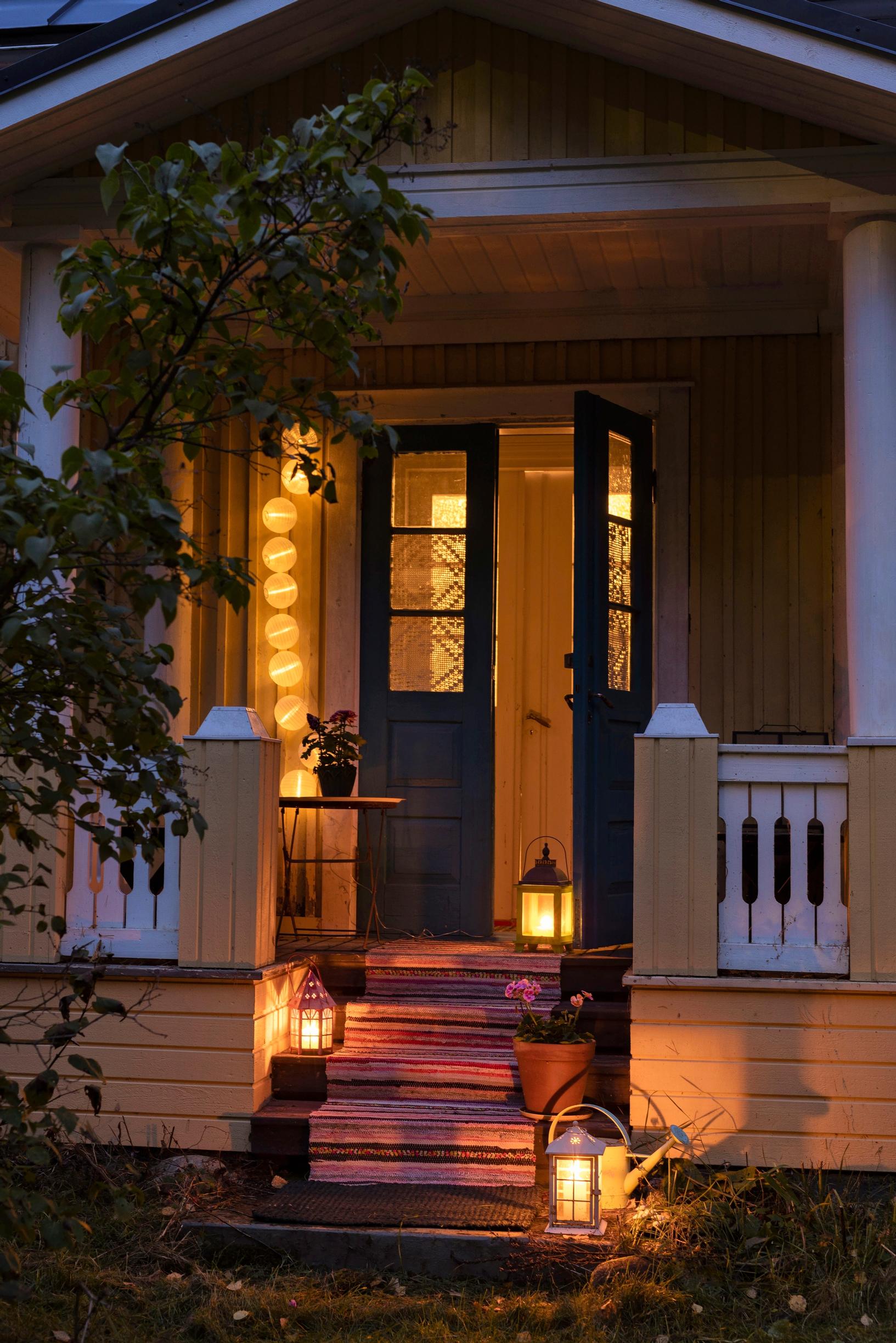 House entrance decorated with lanterns and lights