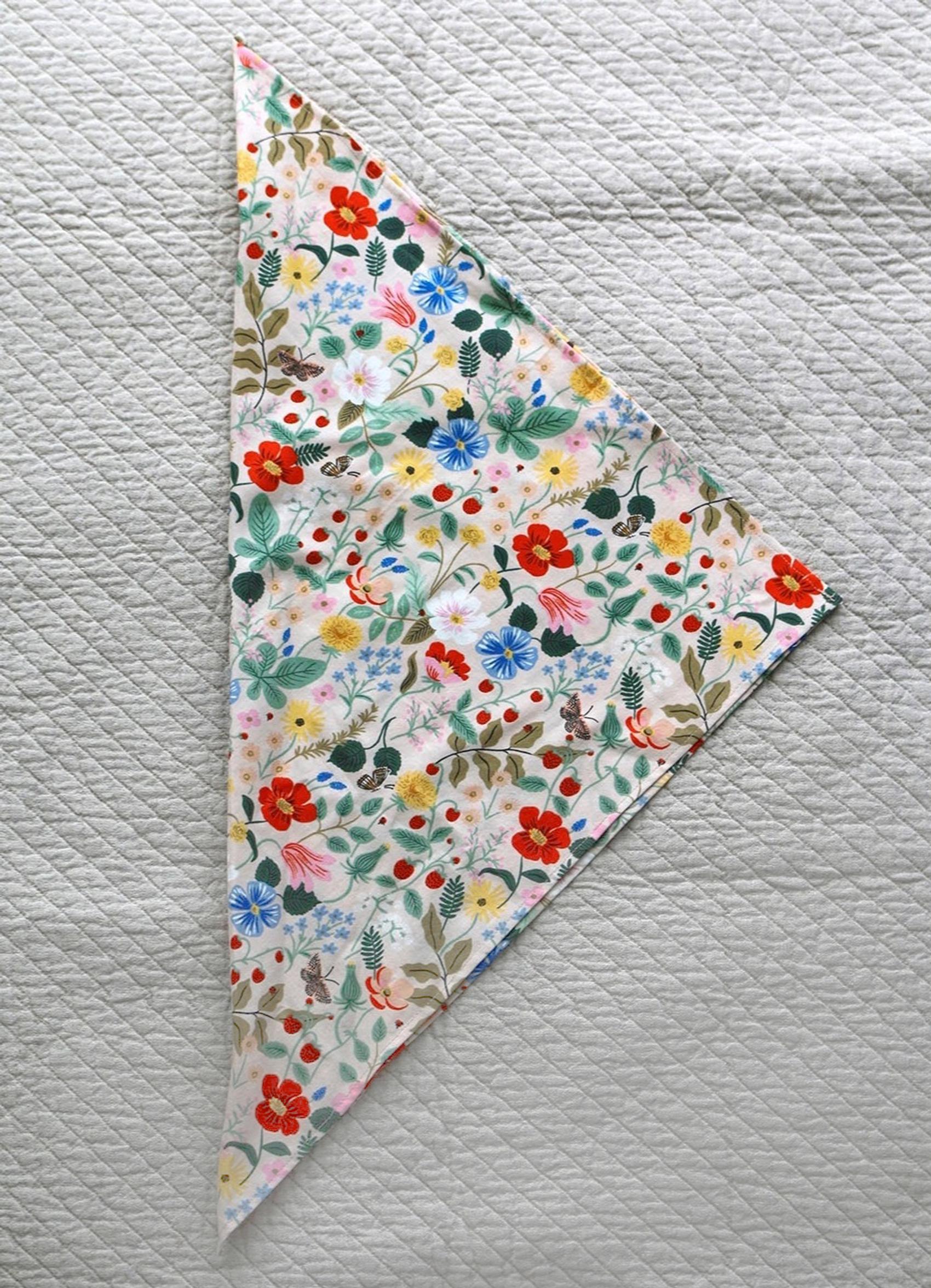 Fold the napkin into a triangle with the wrong sides together.