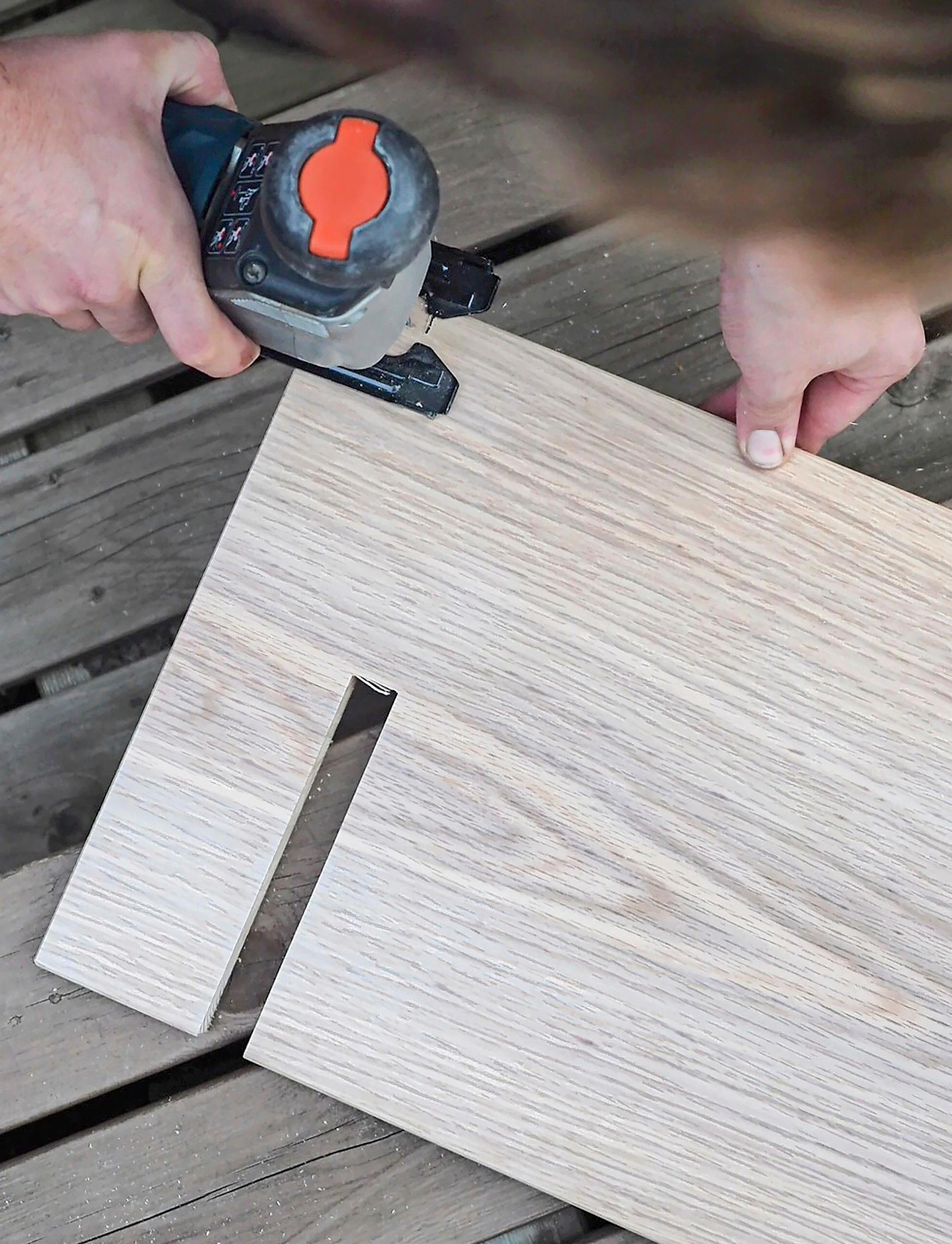 Notching the baseboards of the shelving unit.