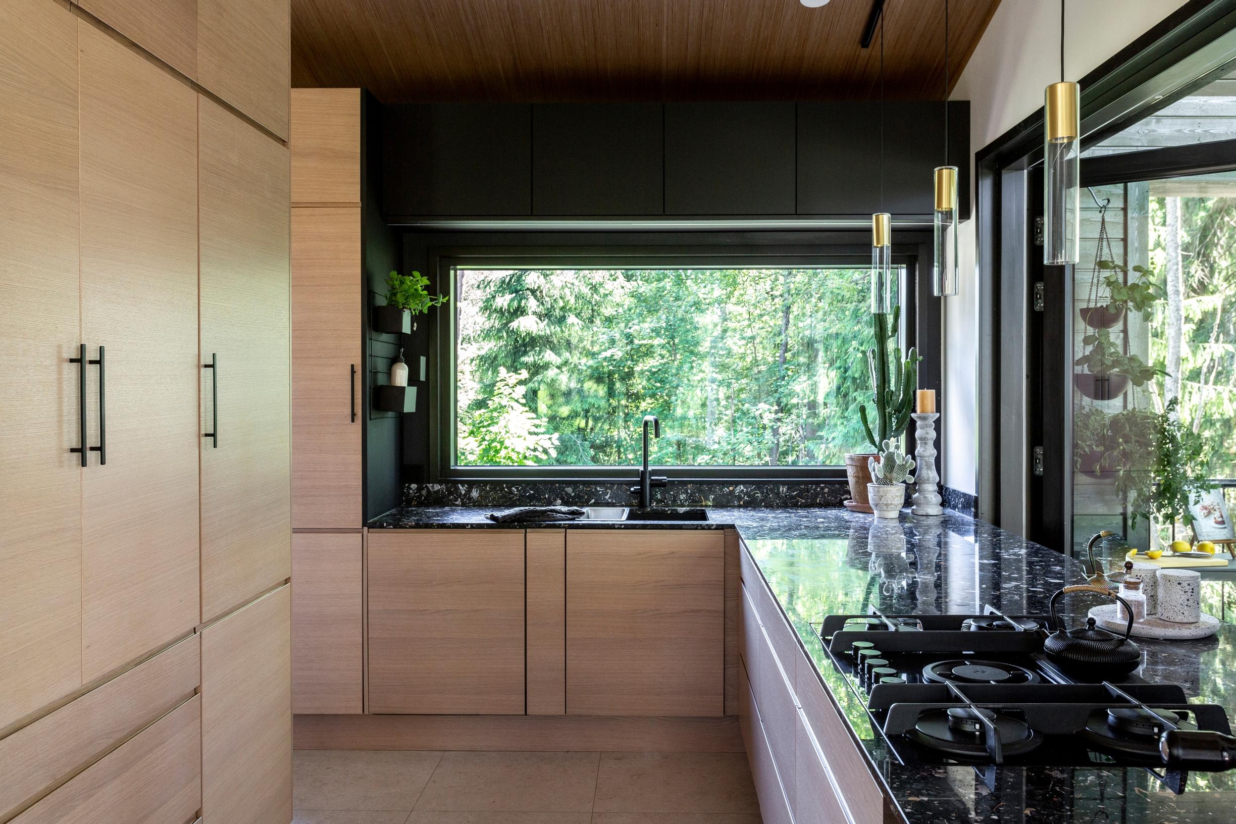 A gas stove and a scenic window in the kitchen.