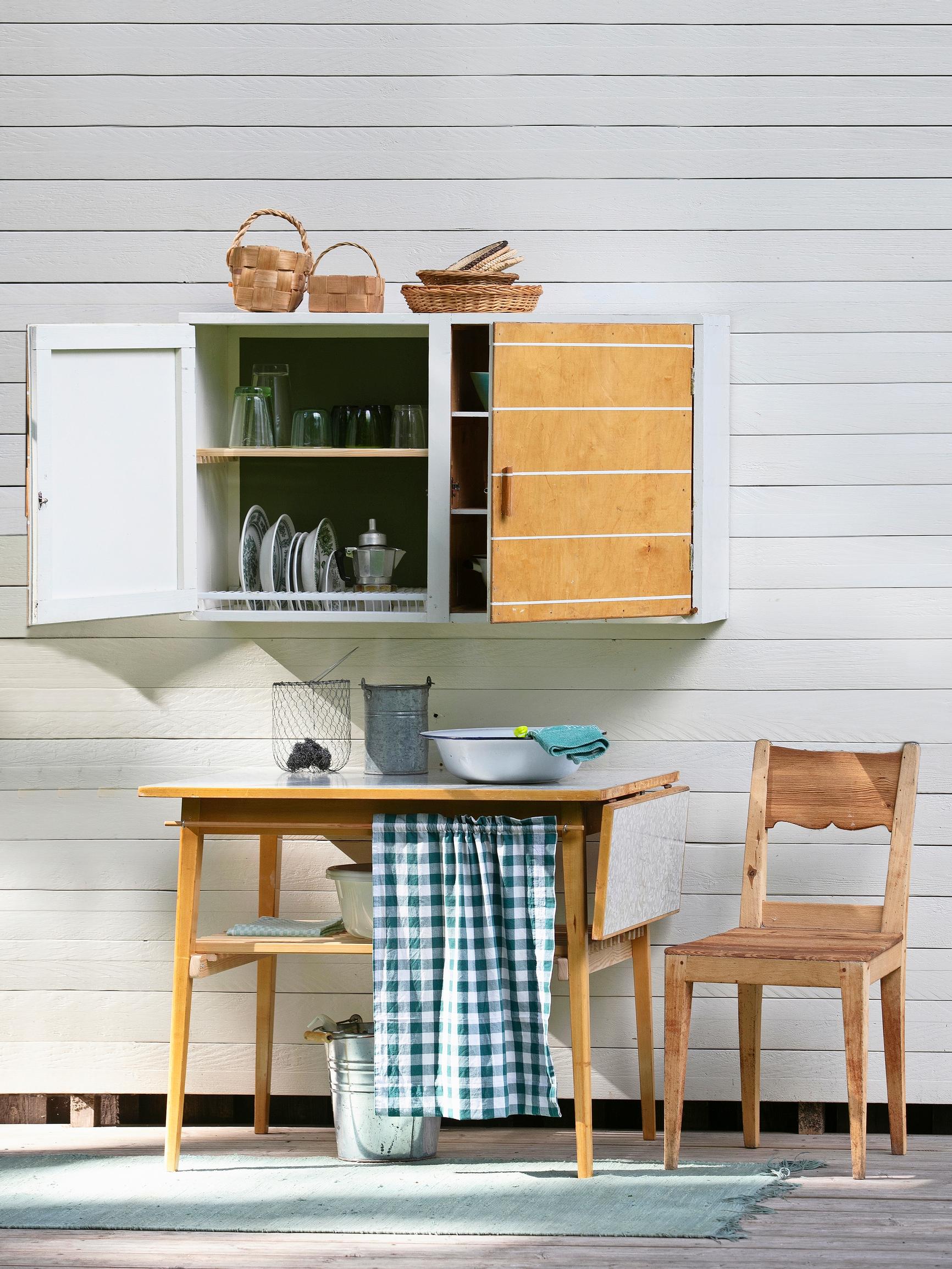 Turn an old cupboard and table into a functional washing station—complete with a dish-drying cabinet