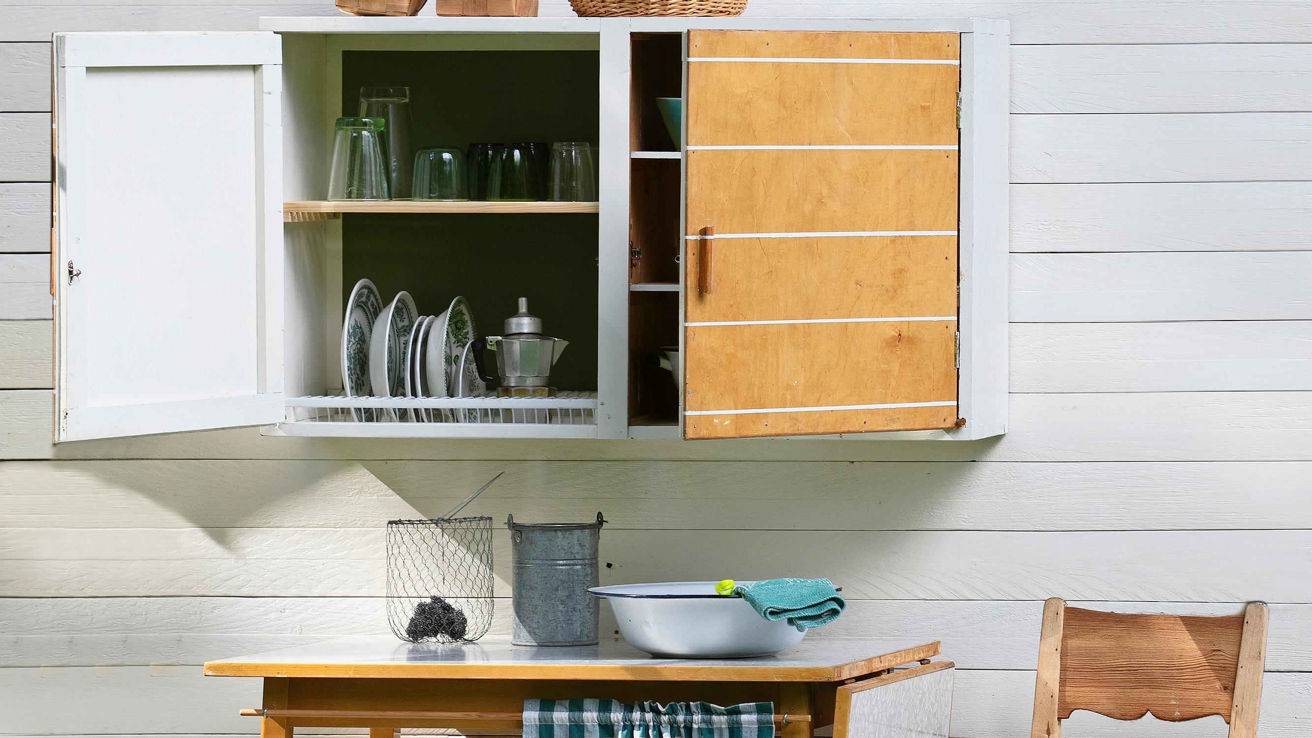 Turn an old cupboard and table into a functional washing station—complete with a dish-drying cabinet