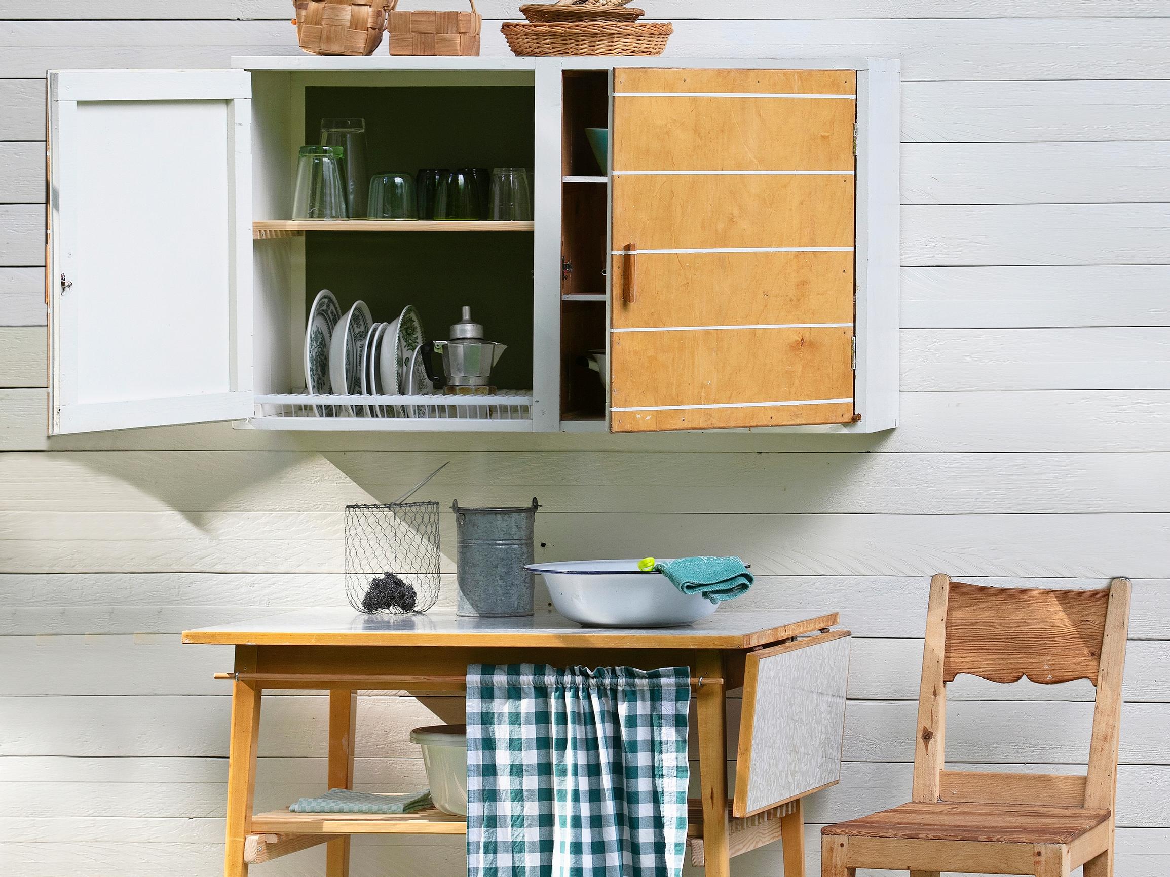 Turn an old cupboard and table into a functional washing station—complete with a dish-drying cabinet