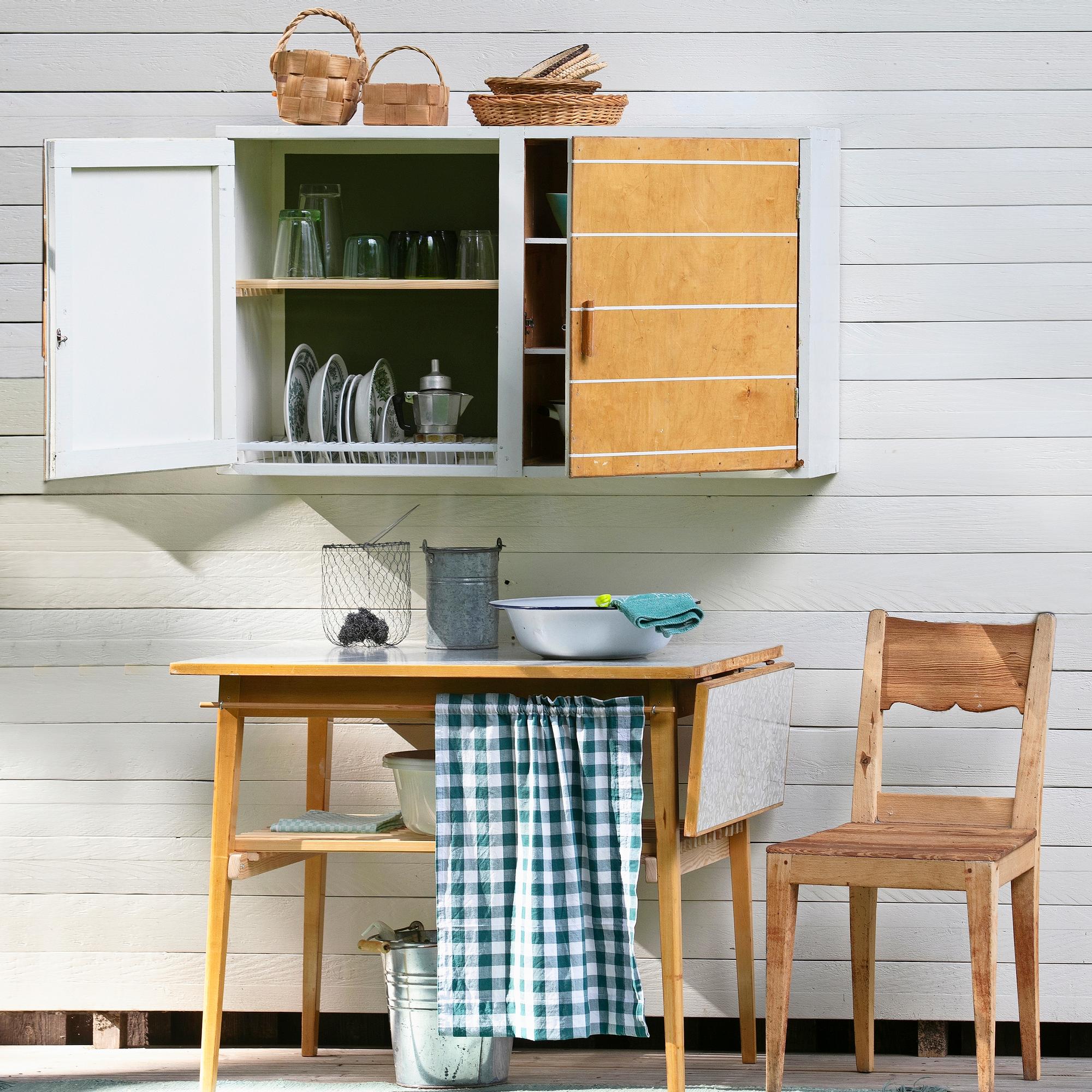 Turn an old cupboard and table into a functional washing station—complete with a dish-drying cabinet