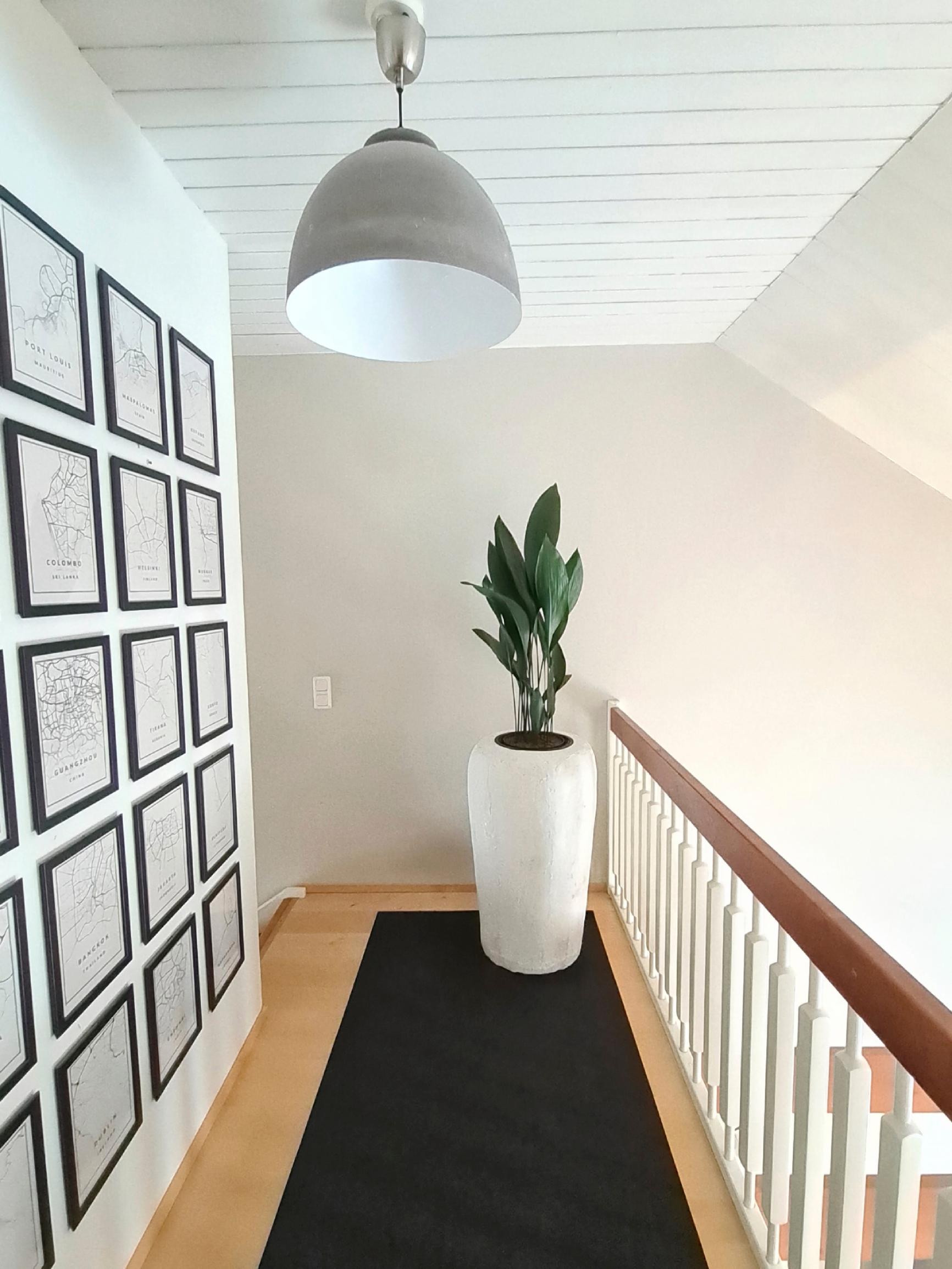 A tall, sculptural white DIY planter for large houseplants.