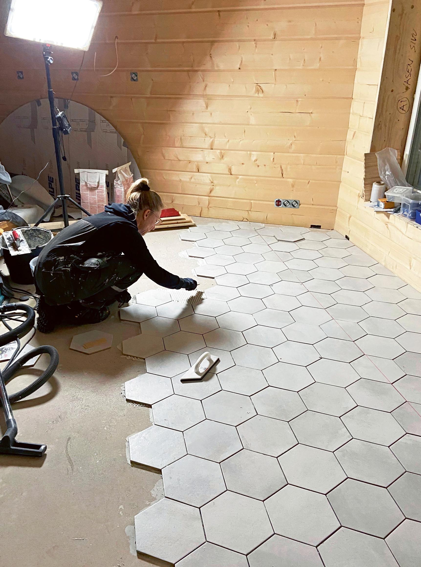 Marjo tiling the floor