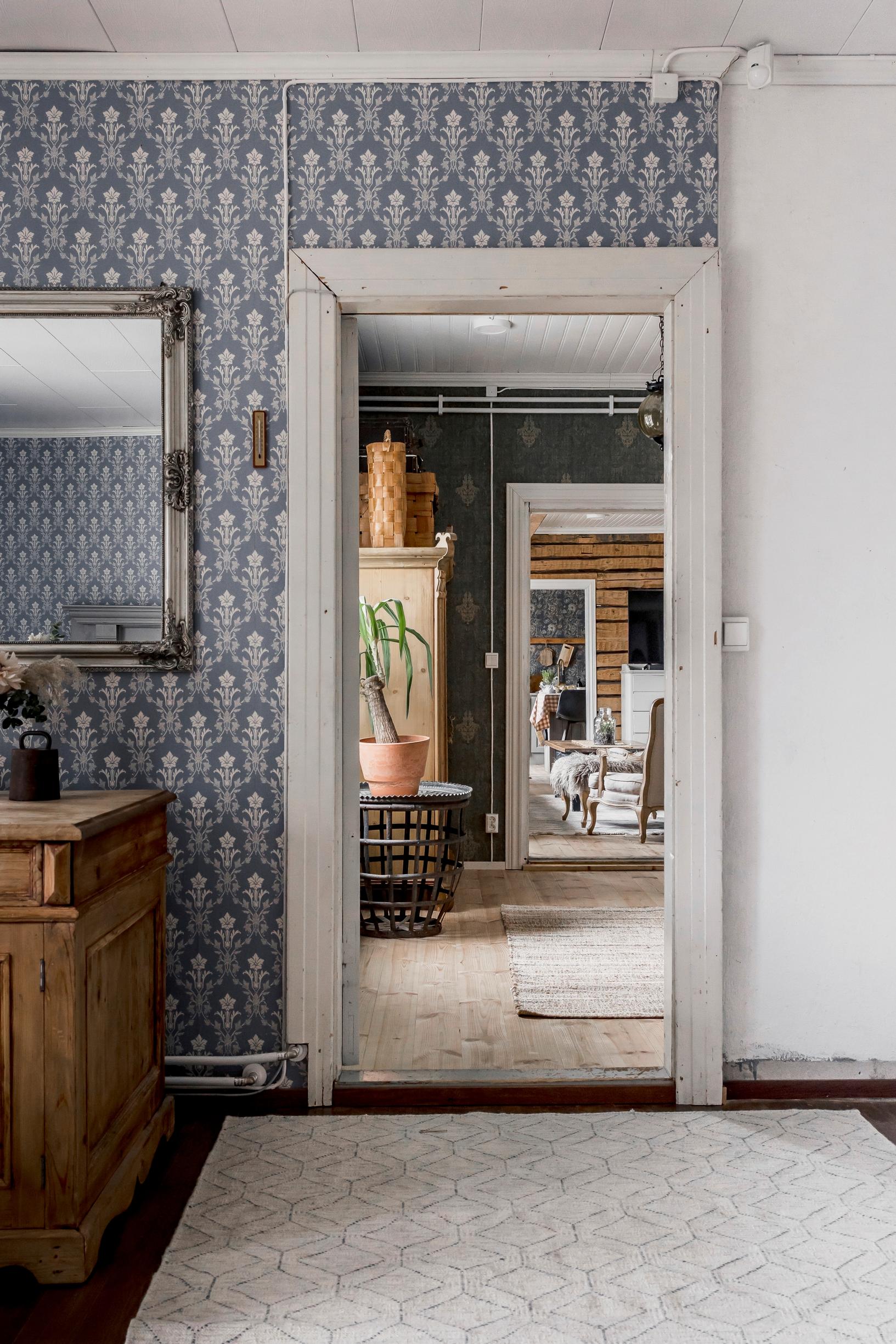 a wallpapered wall and rooms lined up in a row