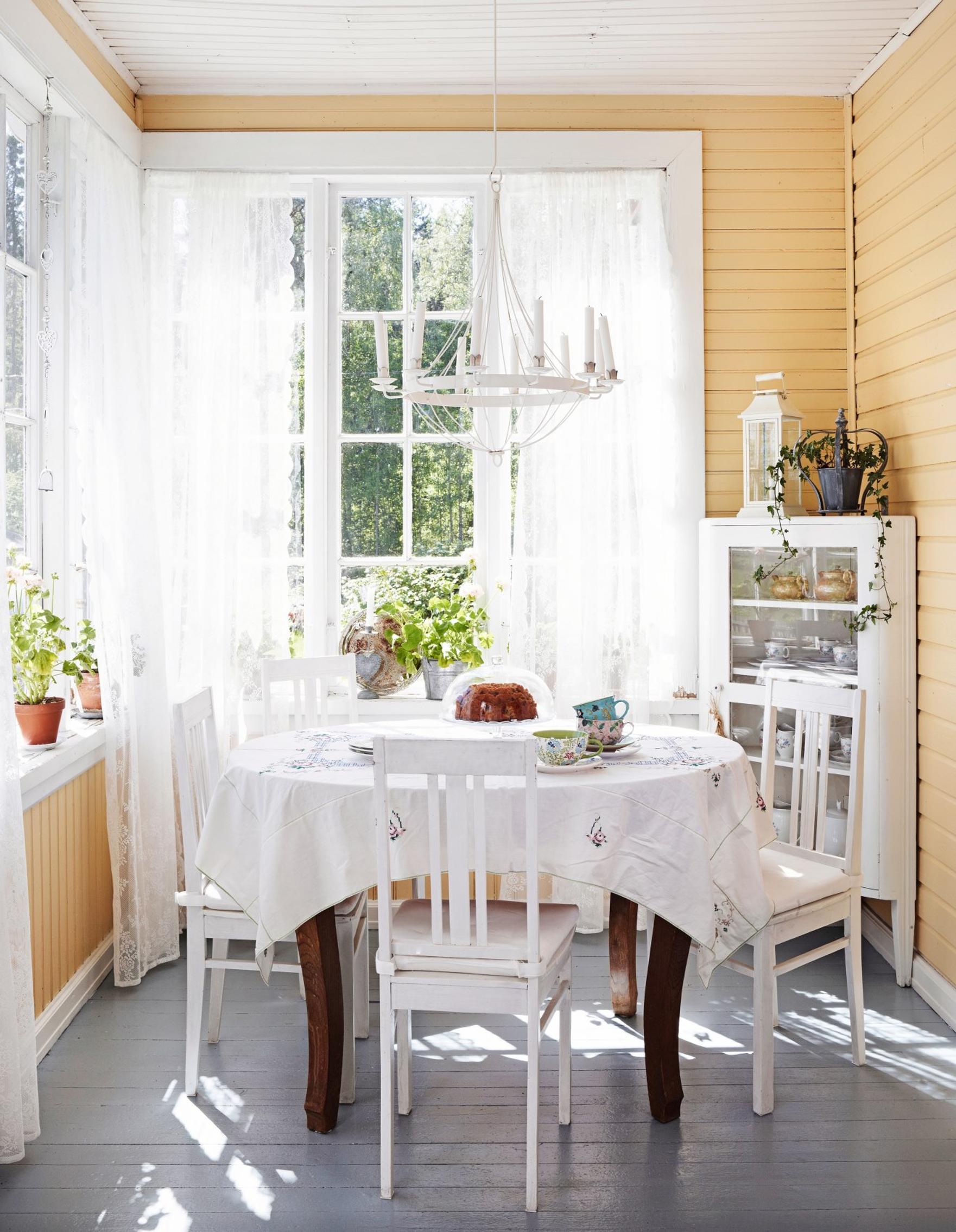 A round dining table on the glass porch