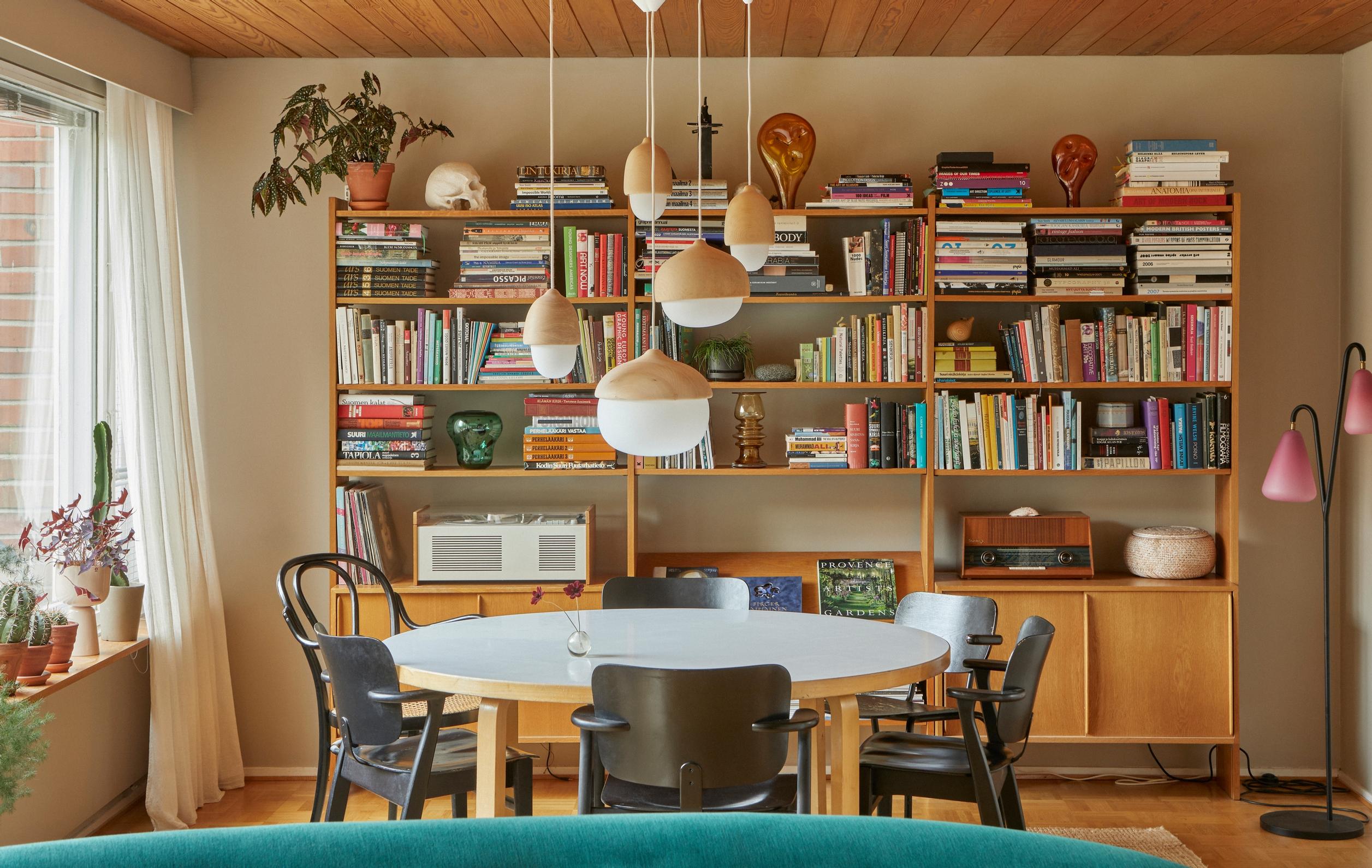 A bookshelf filled with books on mushrooms, art, and design history.