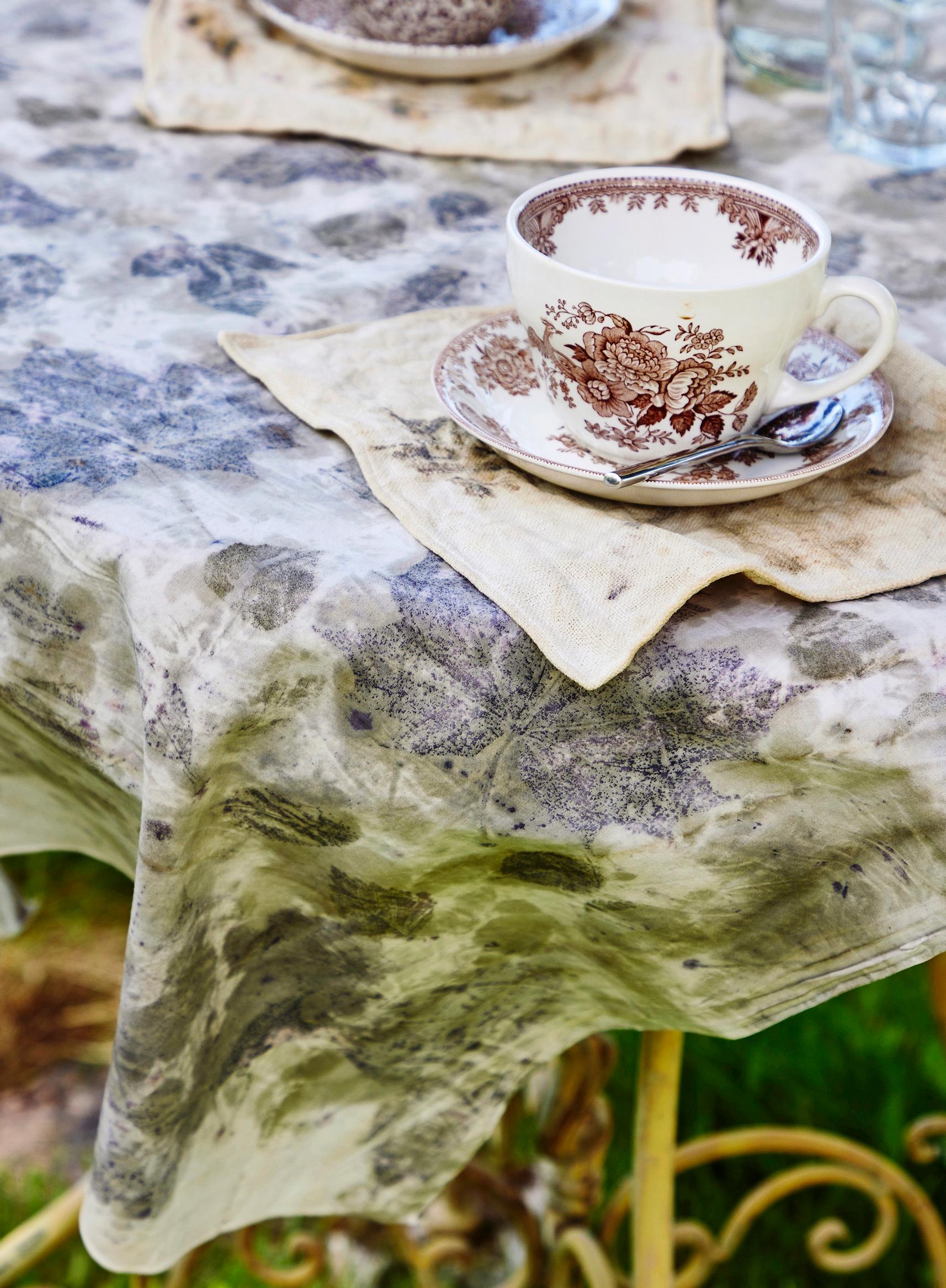 A tablecloth decorated with ecoprinting